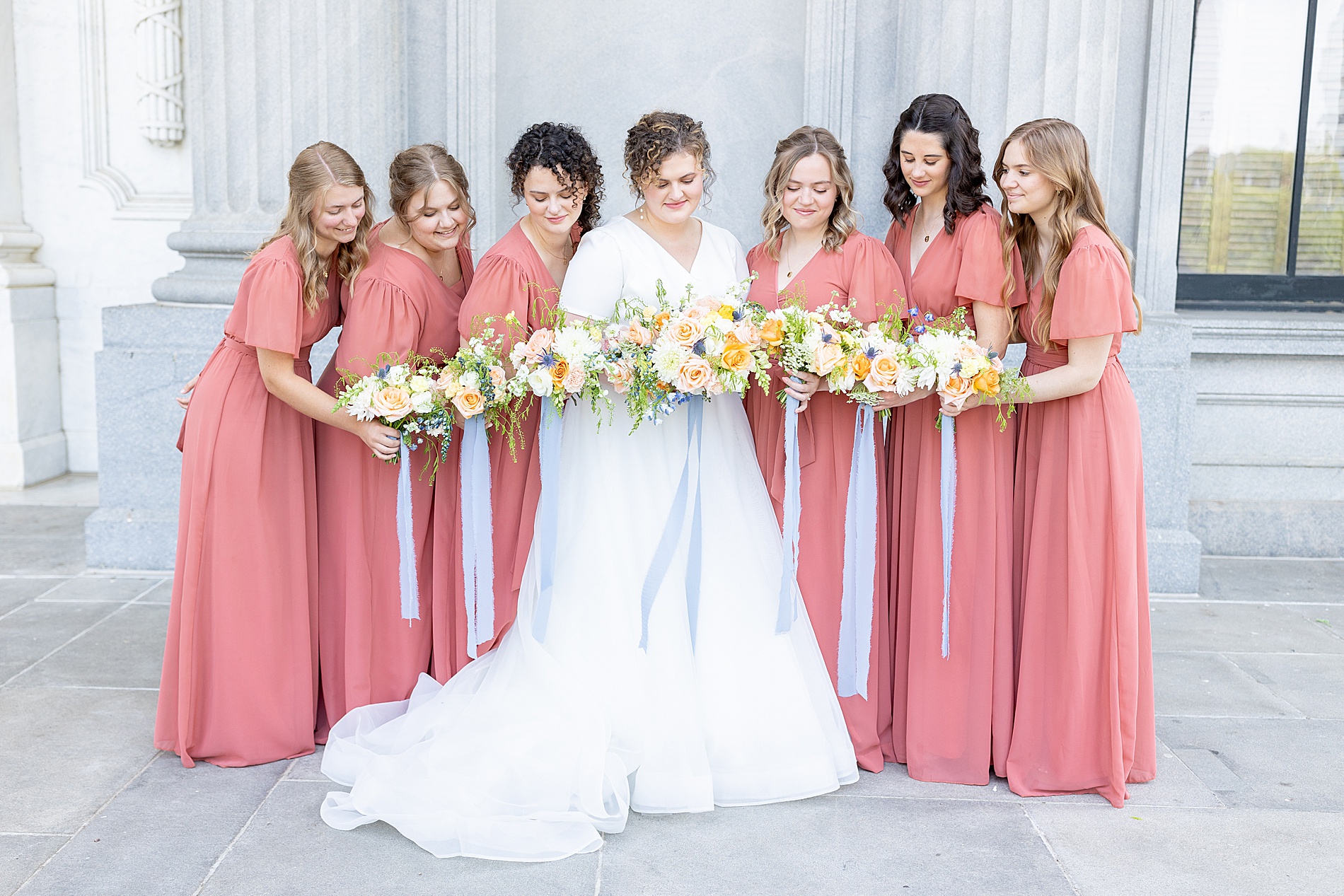 bride and bridesmaids hold bouquets 