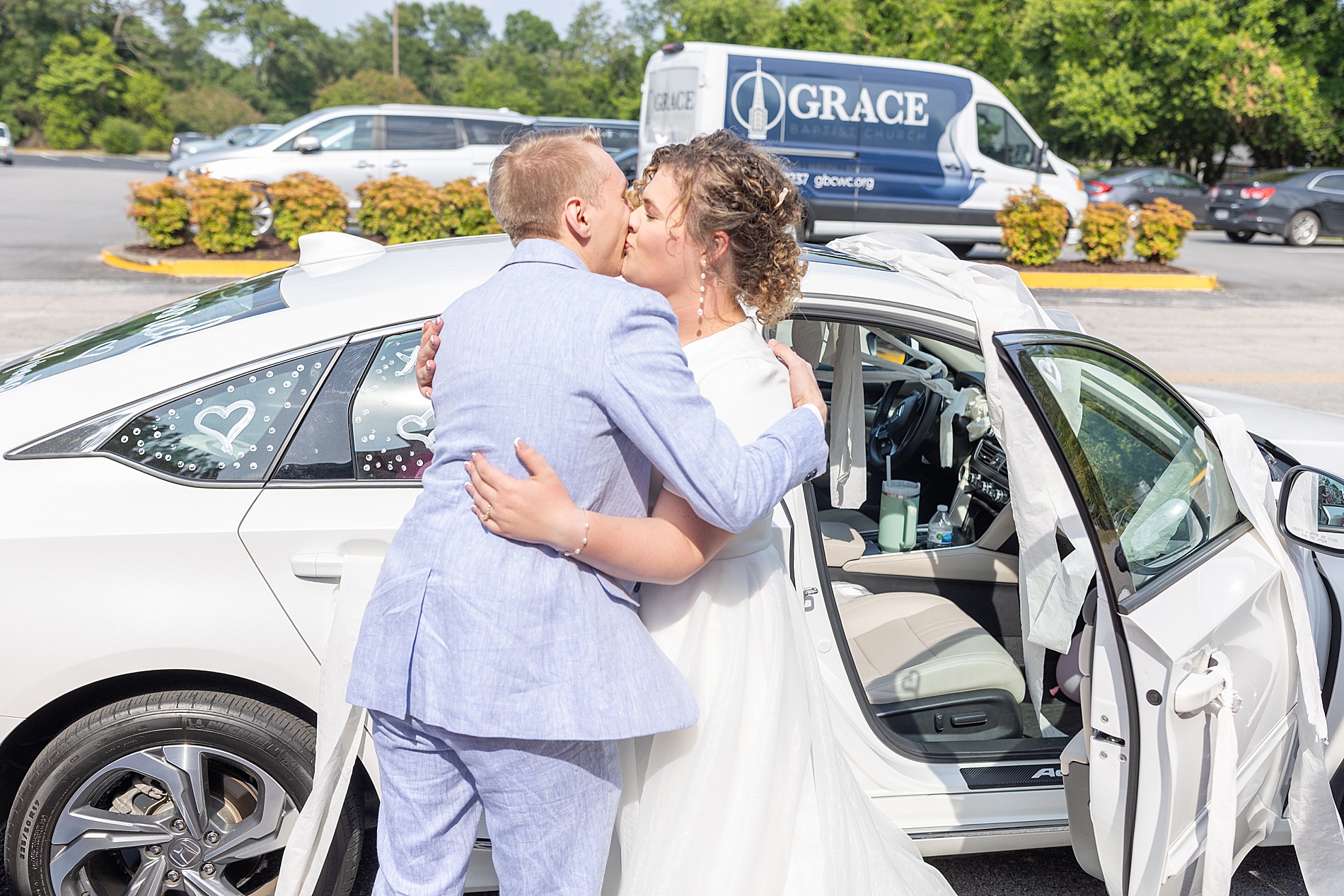 newlyweds kiss before getting in getaway car