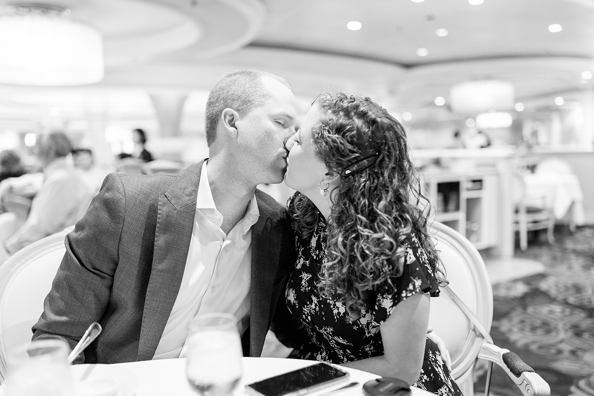 couple kiss at dinner aboard cruise 