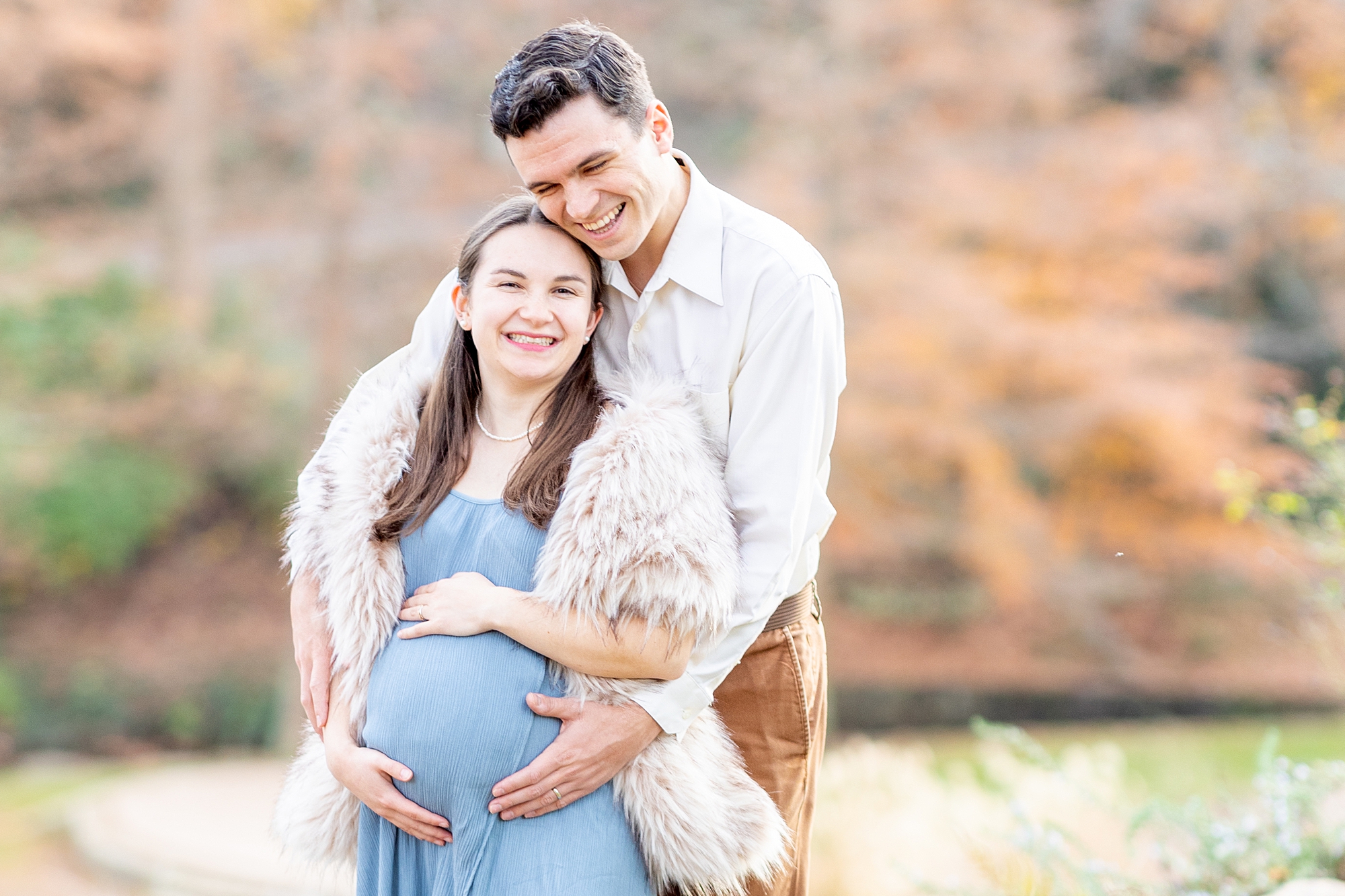 candid maternity portraits of couple laughing