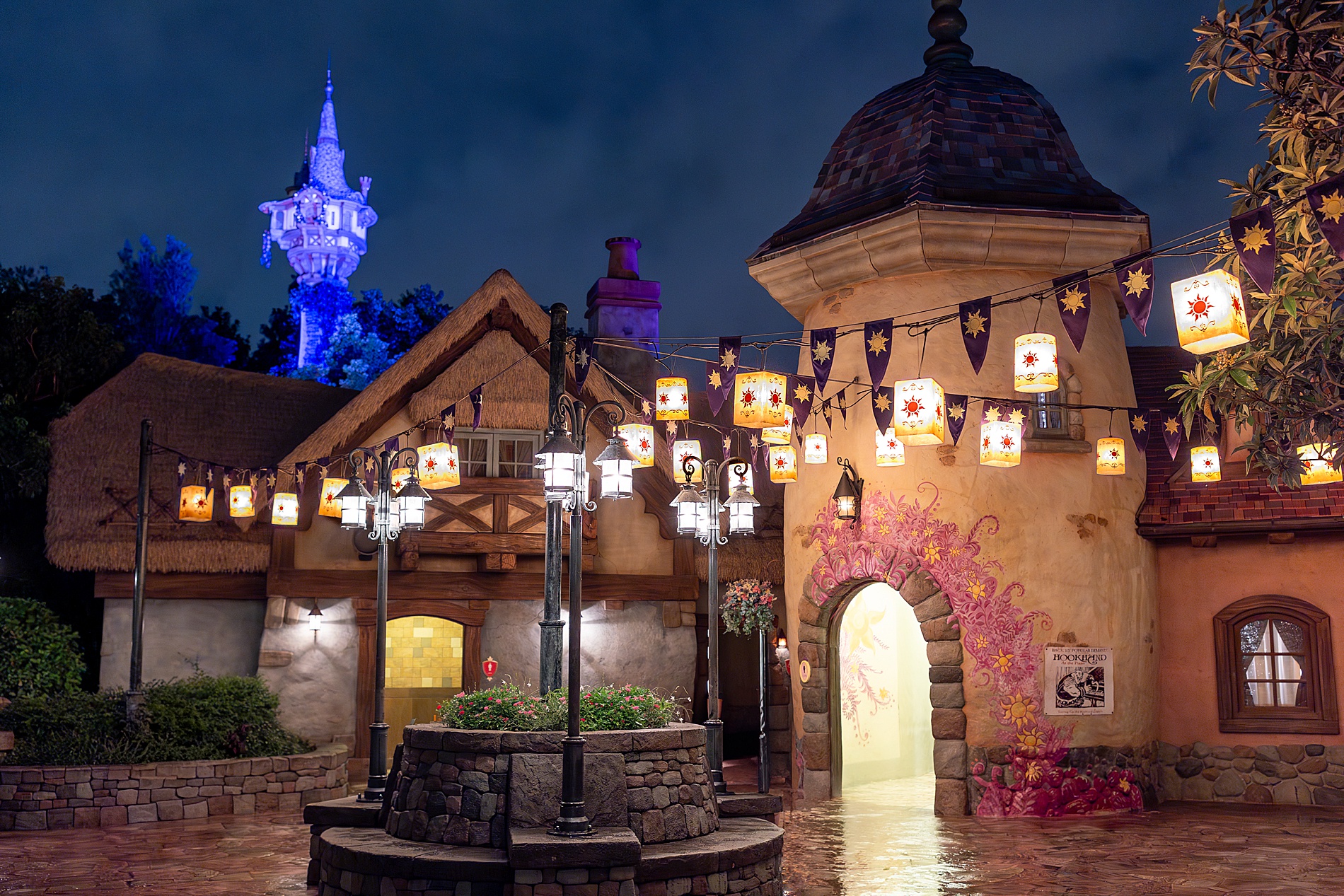tangled themed building with lanterns lit up at night