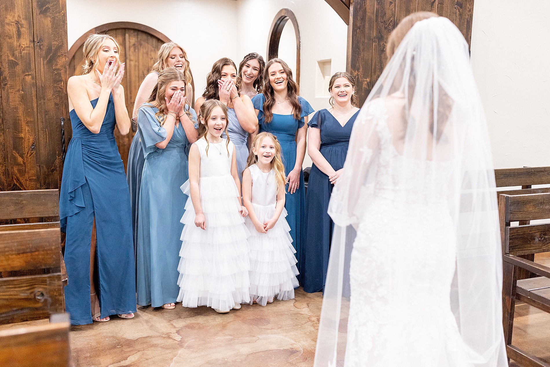 bridesmaids react to seeing bride for the first time in wedding dress