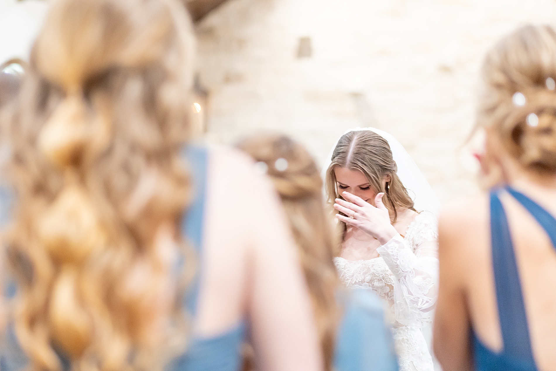 bride gets emotional during first look with bridesmaids