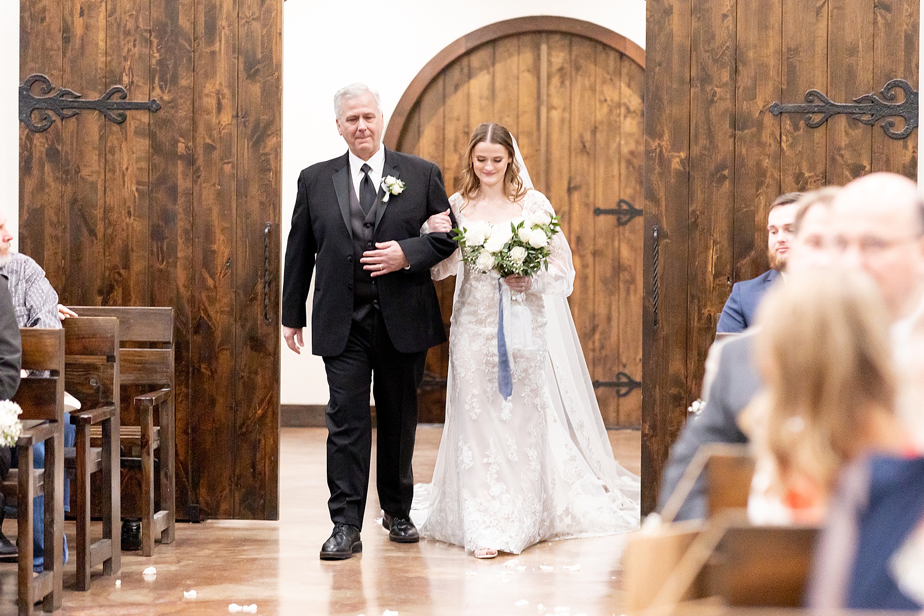 bride walks down the aisle with father 