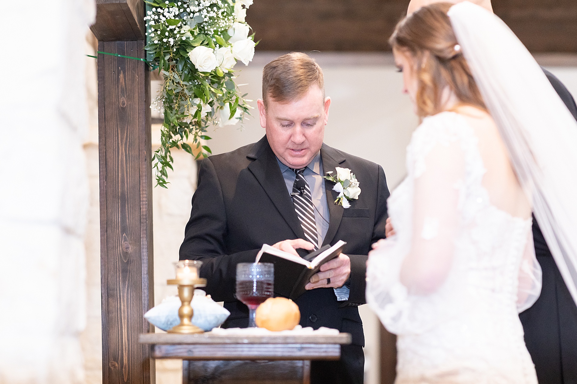 couple share communion during wedding ceremony