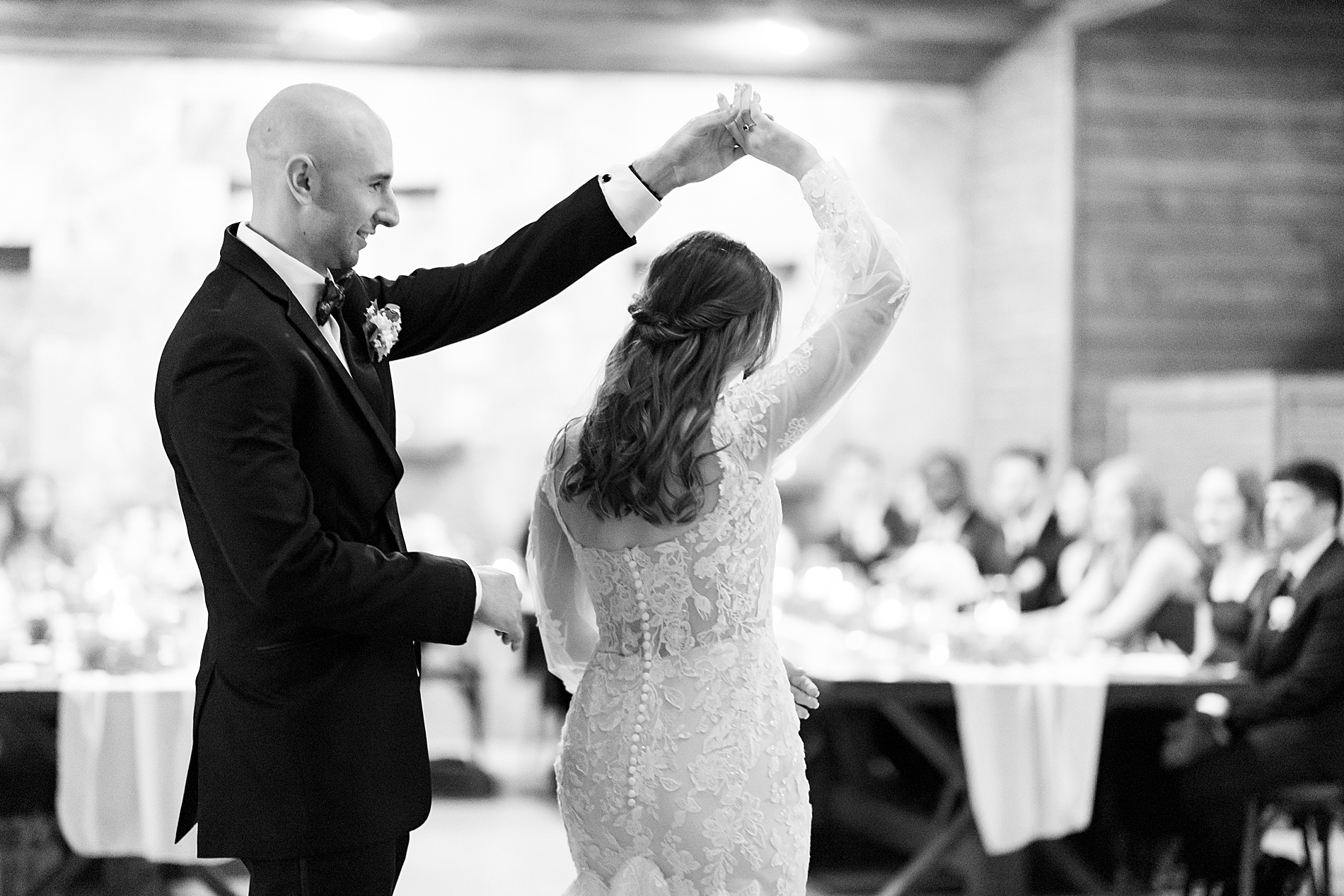 groom spins bride on dance floor