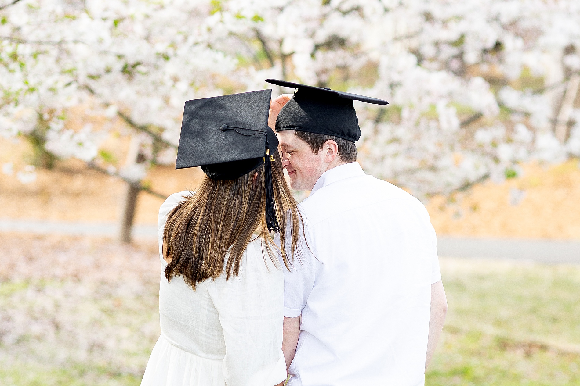 Legacy Park Spring Graduation Session of couple in graduation caps 