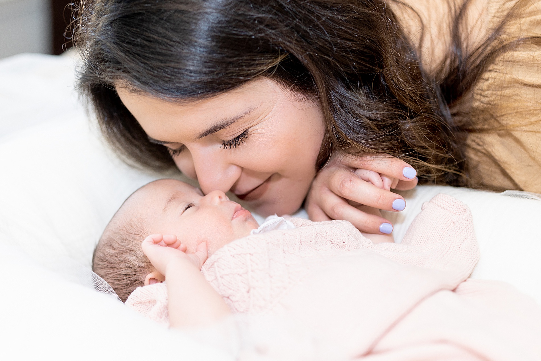 mom snuggles her newborn during Greenville In-Home Newborn Session 