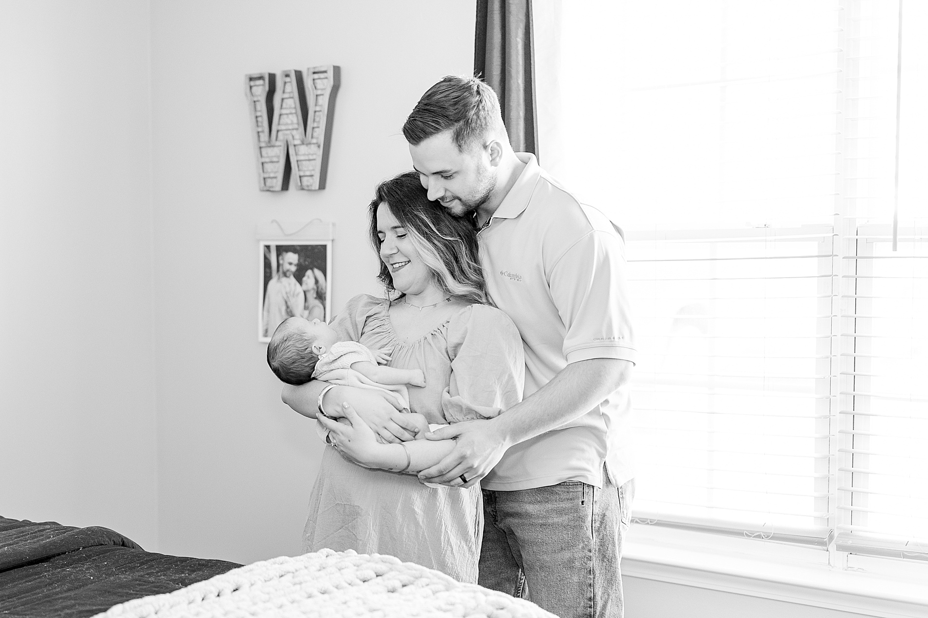 parents hold their baby girl during In-Home Newborn Session 