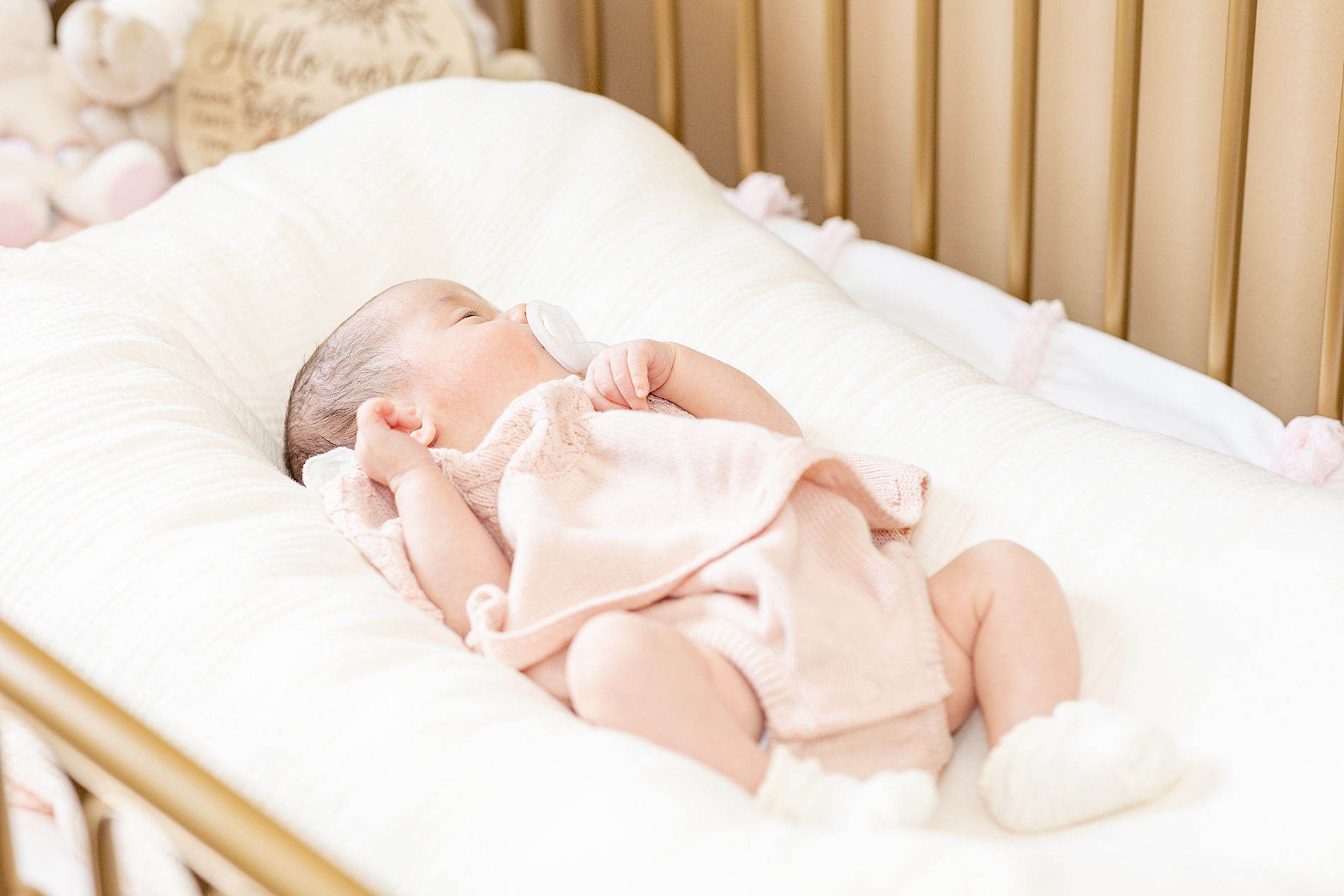 sleepy newborn girl in crib 