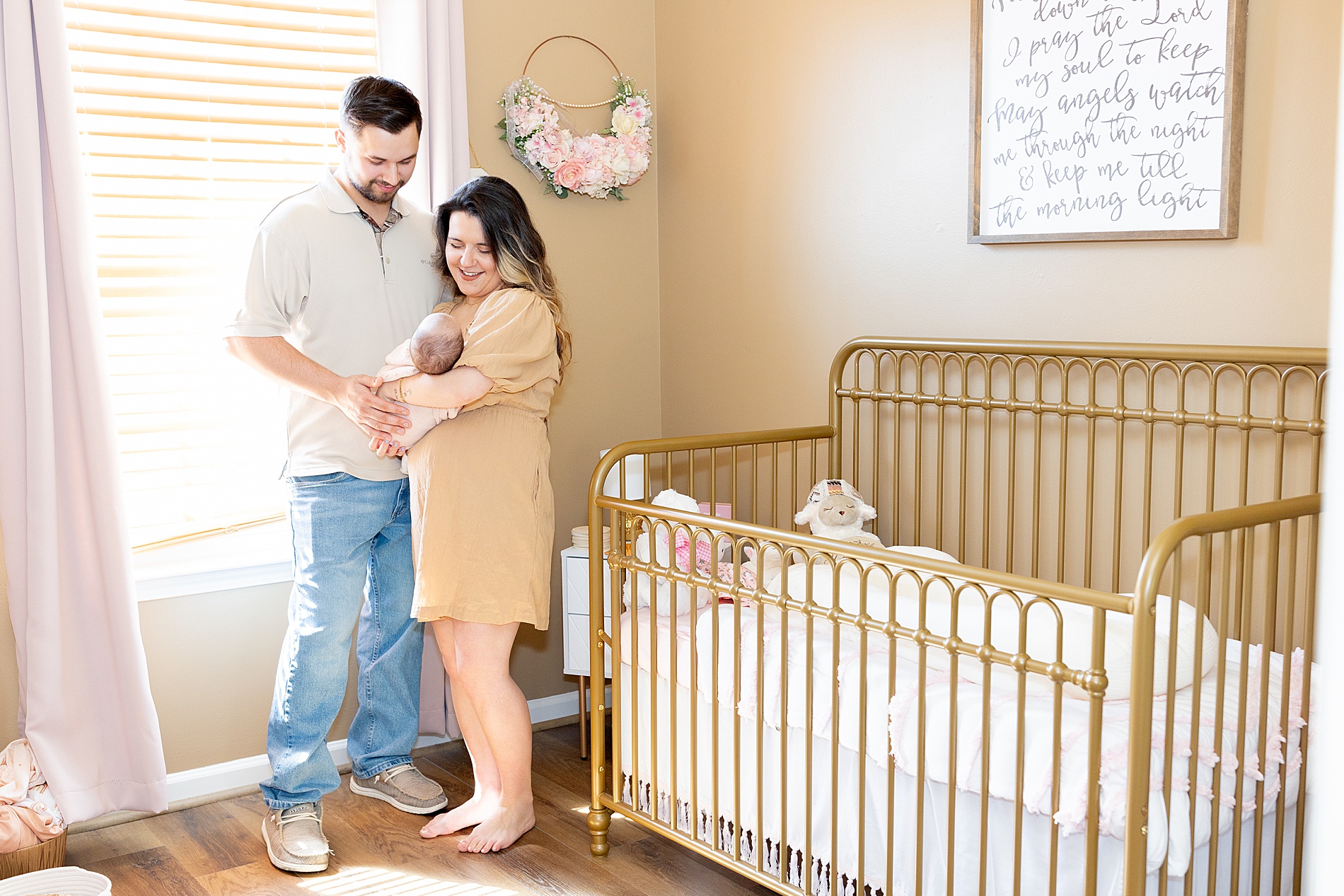 parents in baby girl nursery during Greenville In-Home Newborn Session 