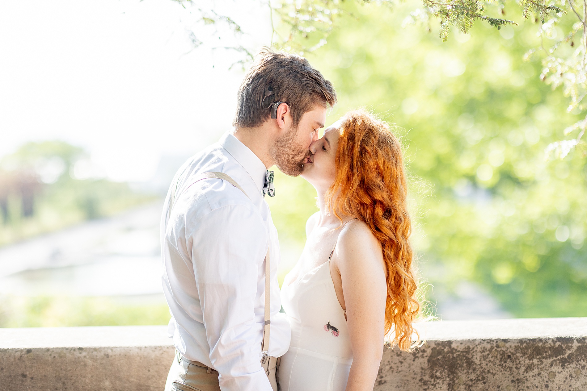 couple kiss under tree