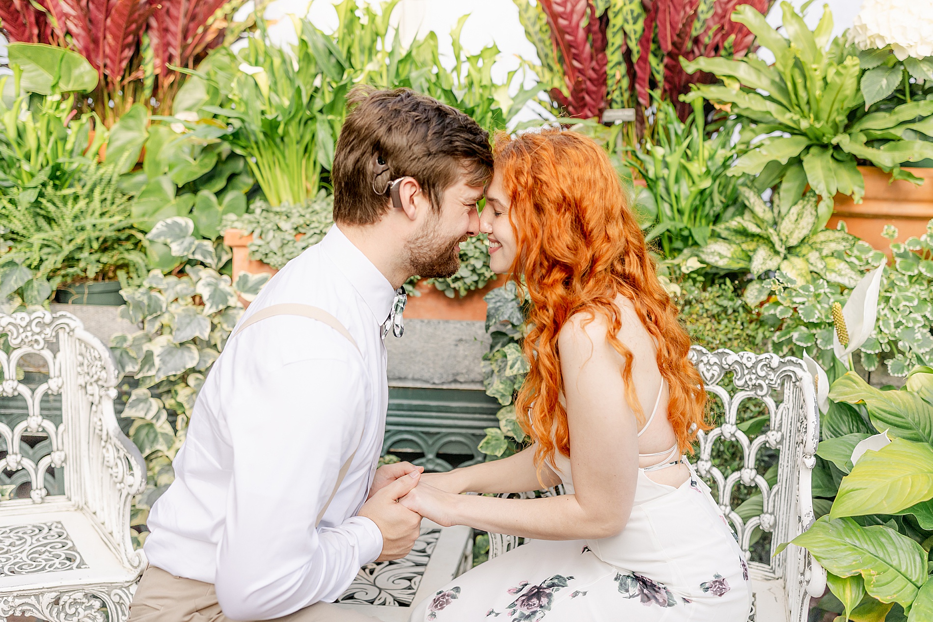 couple sit in conservatory during Romantic Biltmore Estate Engagement Session