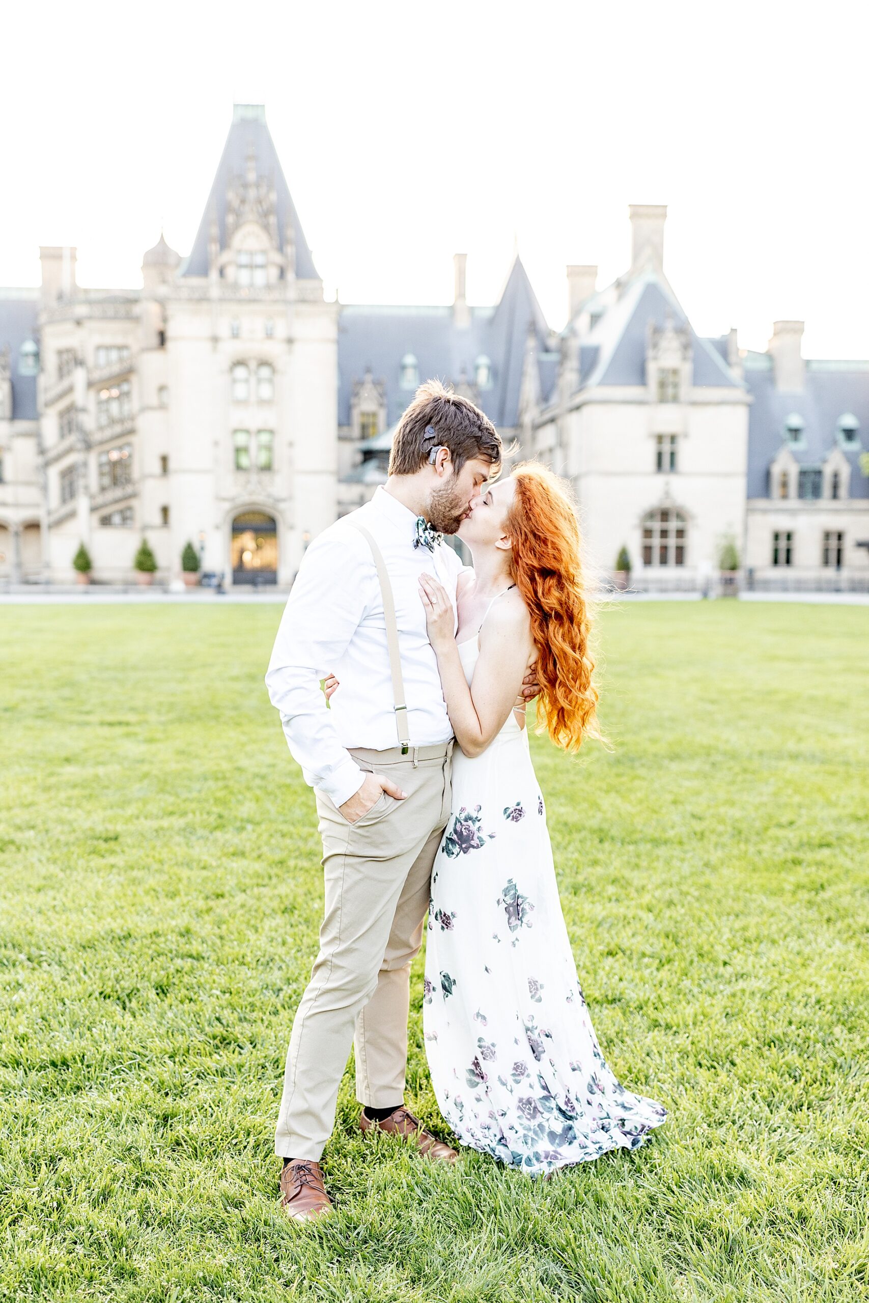 couple kiss in front of Biltmore Estate  