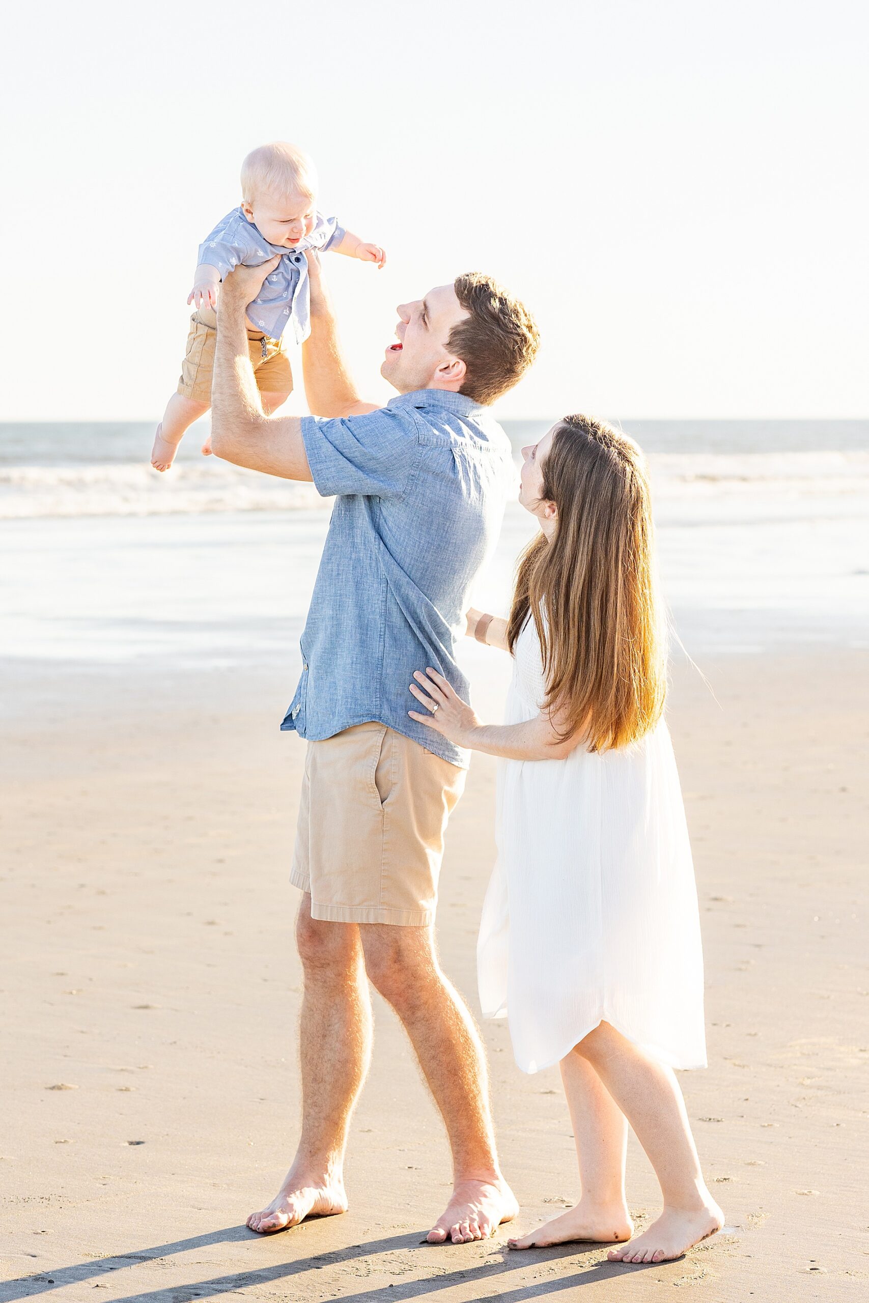 dad lifts his son in up in the air