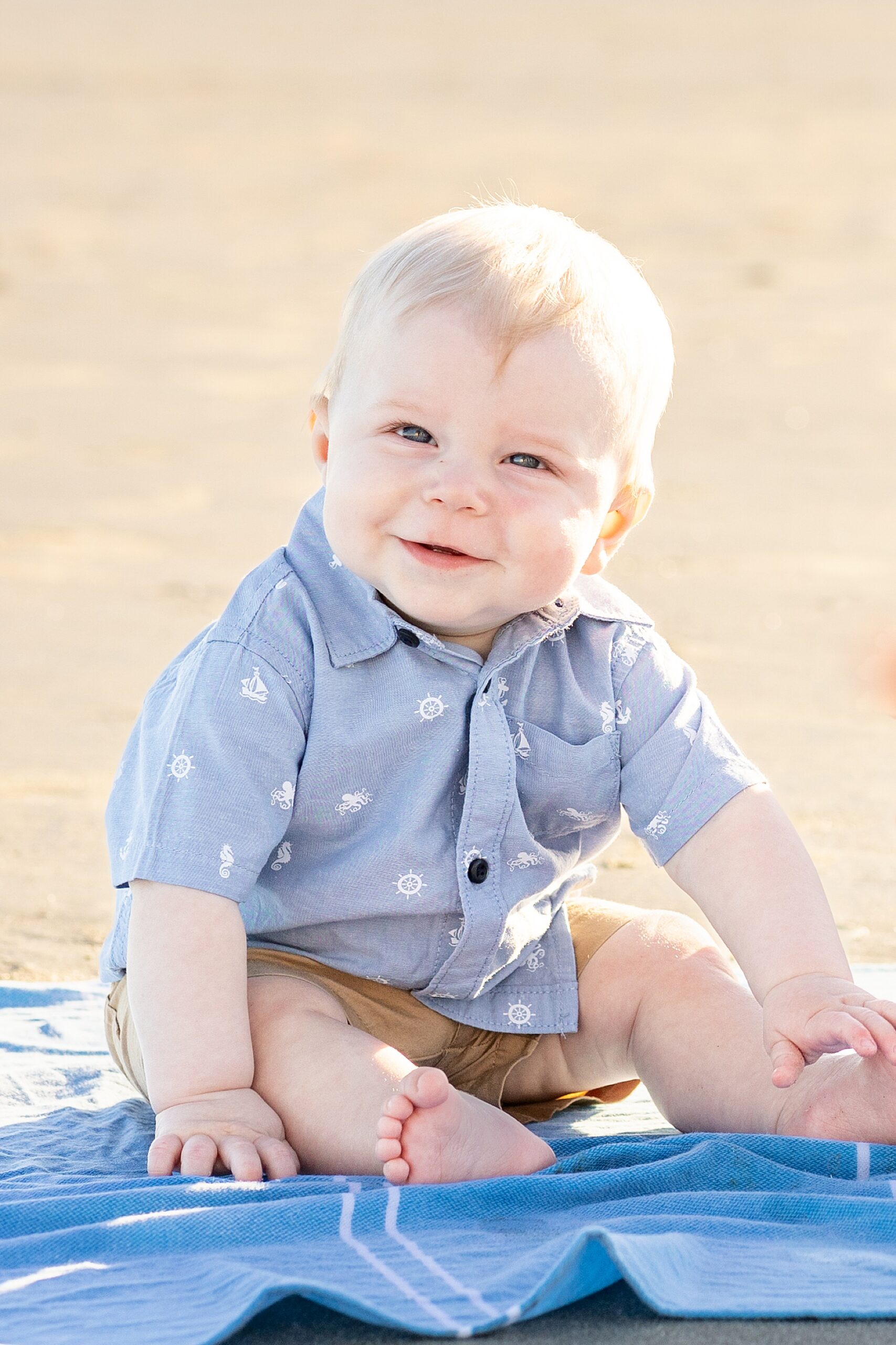 baby boy on blanket during family photos on the beach