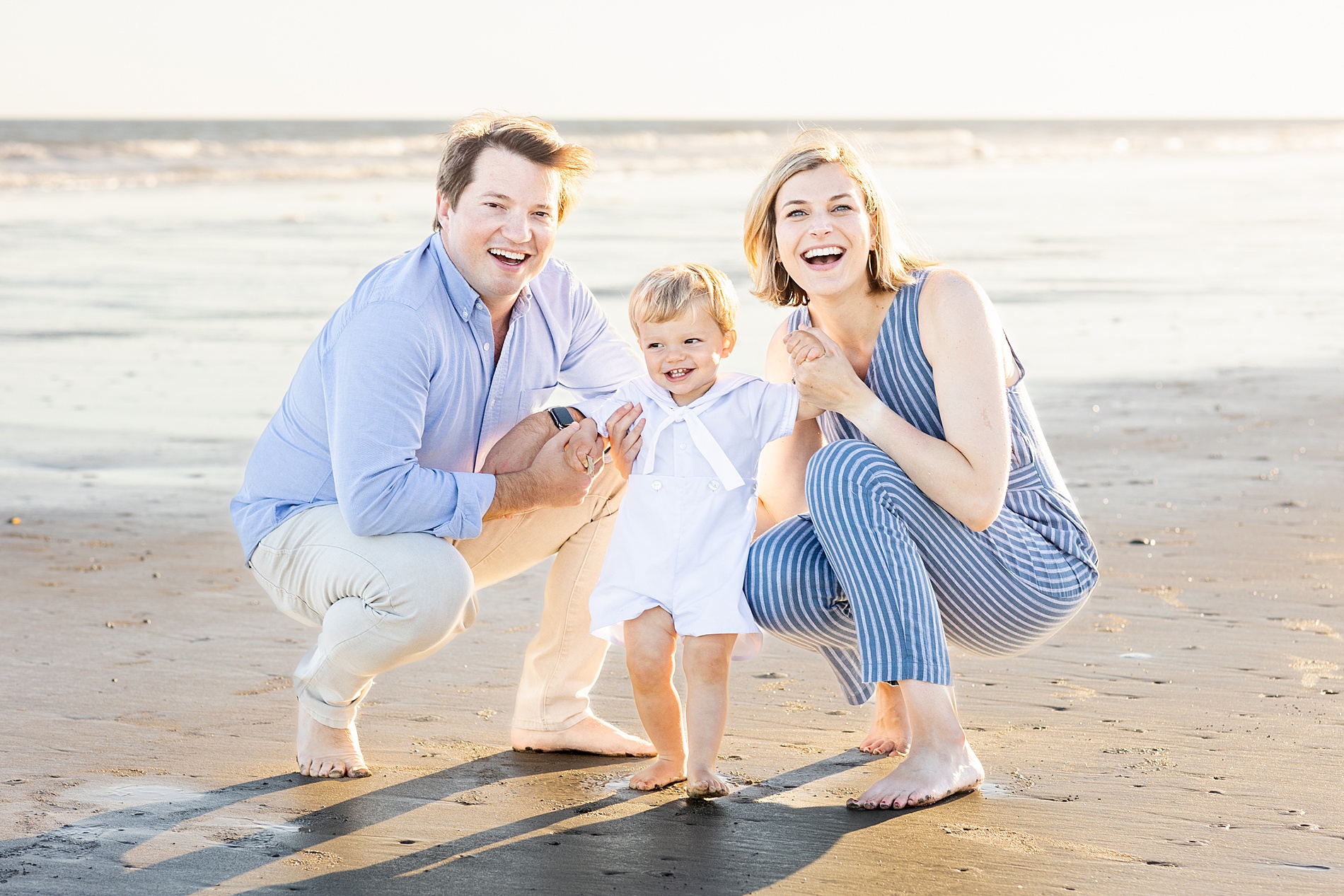 family of three on the beach