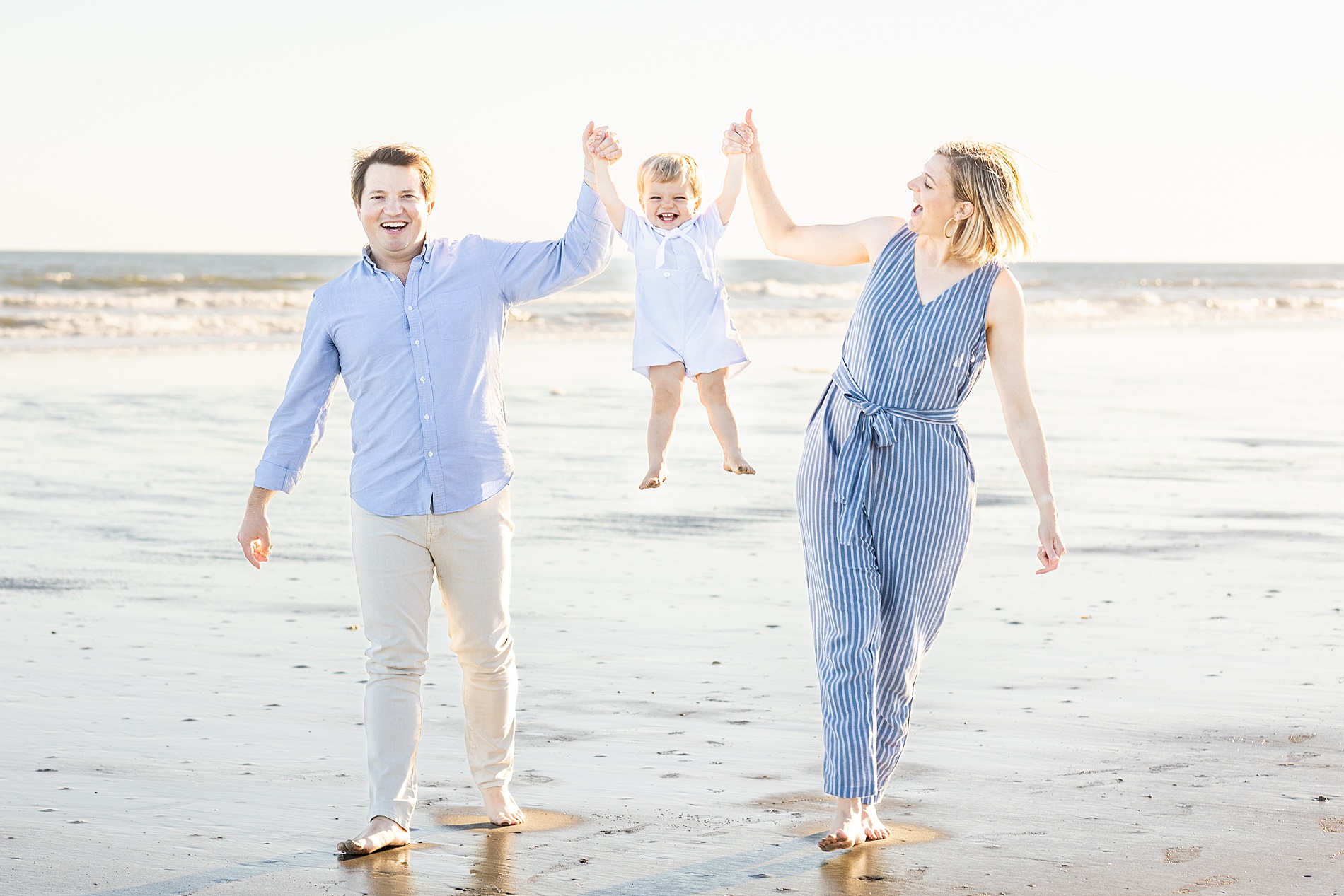 parents lift their son up in the air