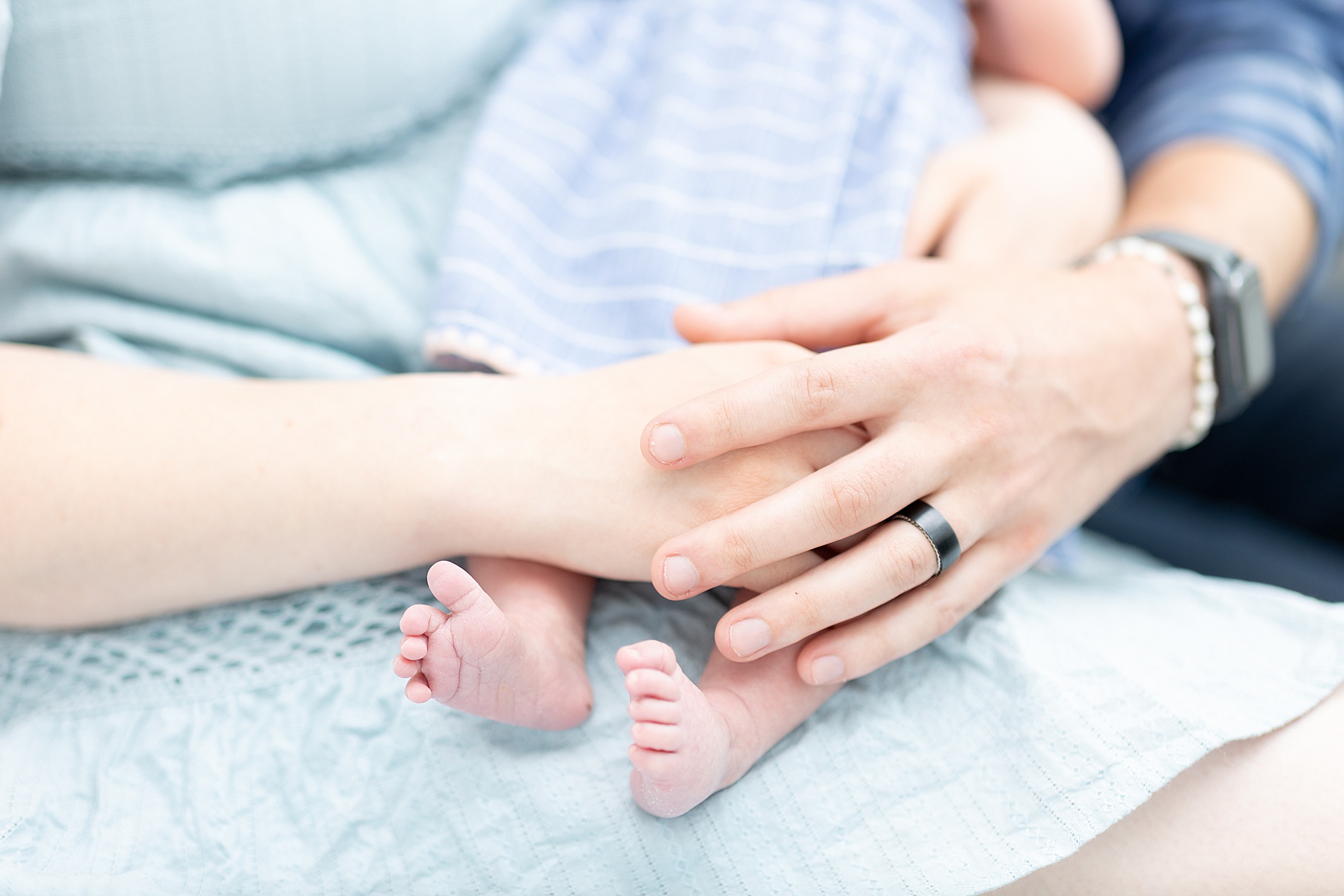 parents hold newborn girl