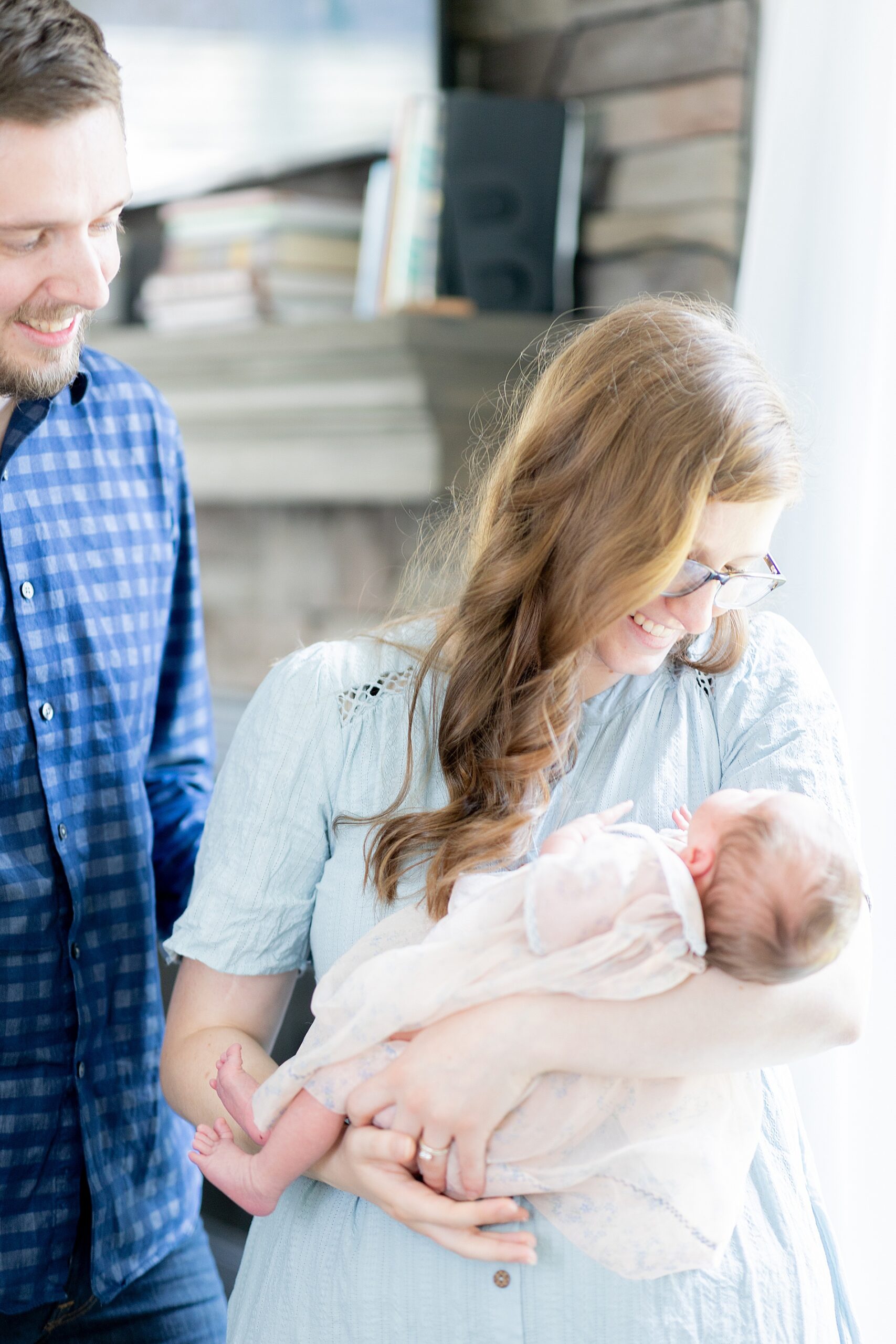 parents look down at their baby girl