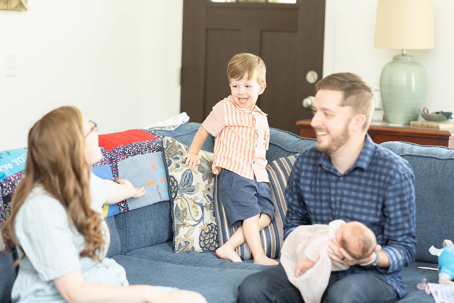 candid photo of family of four on couch