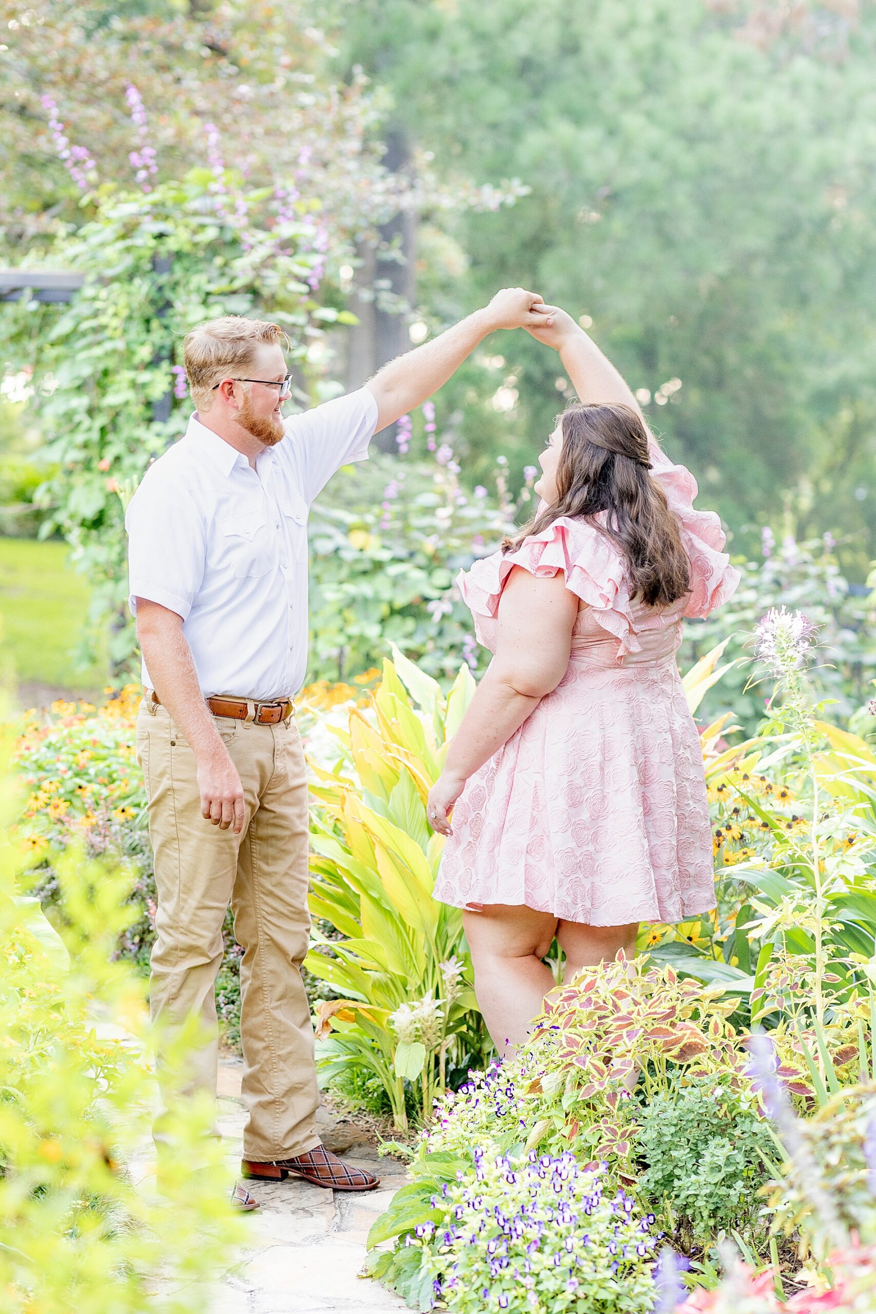 candid engagement photos at Tyler Rose Garden