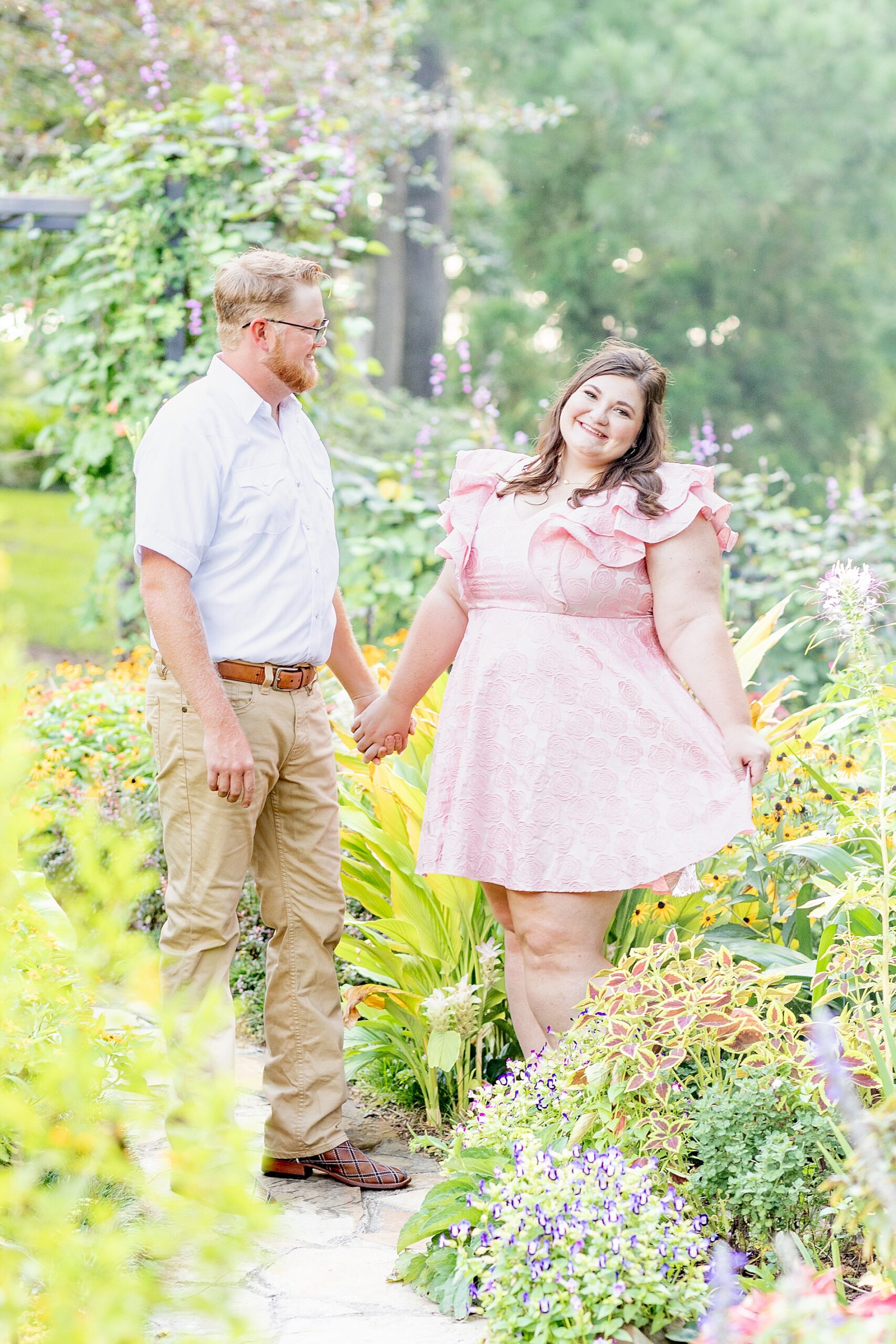 couple in garden surrounded by flowers