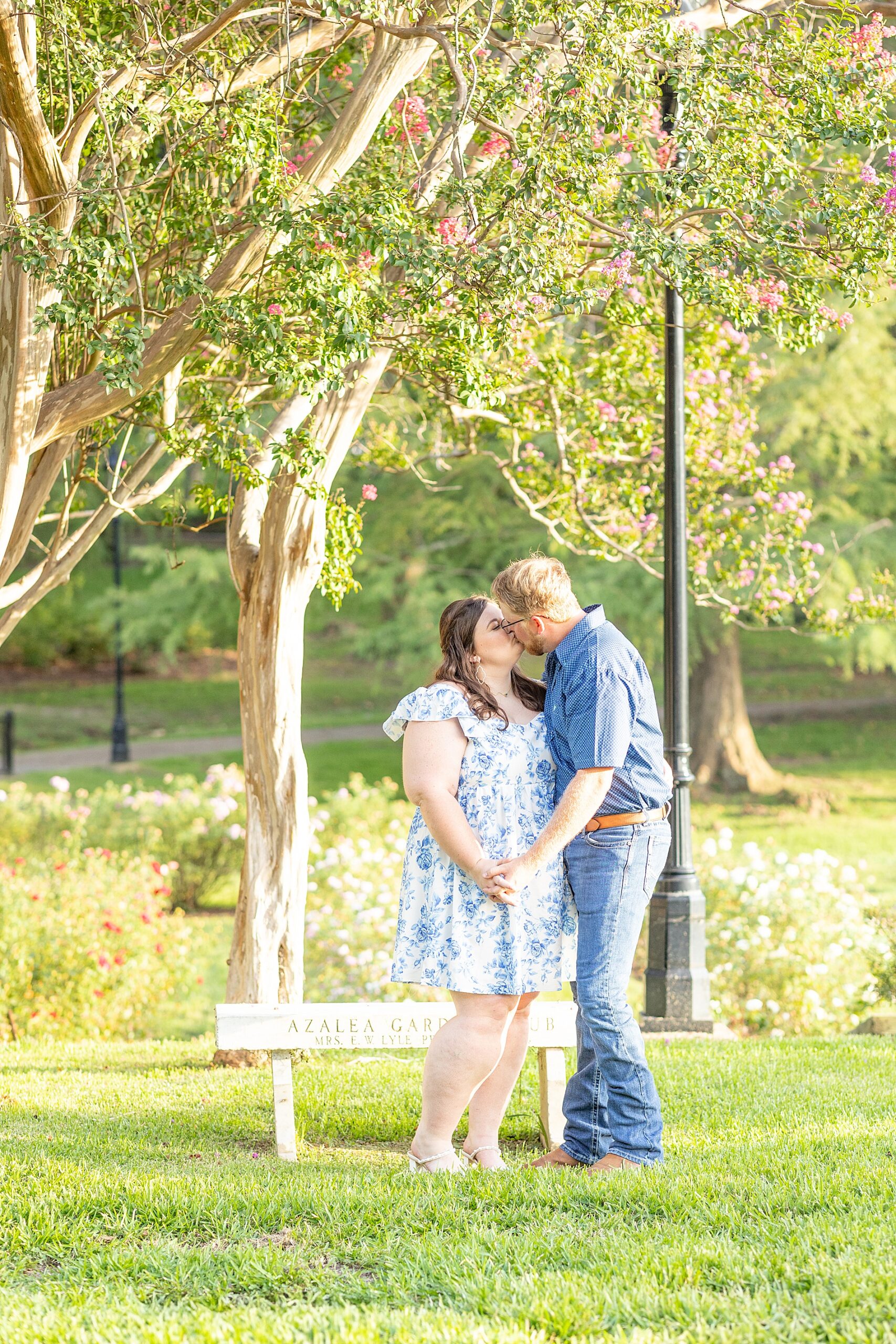 couple kiss during Dreamy Engagement Session at Tyler Rose Garden