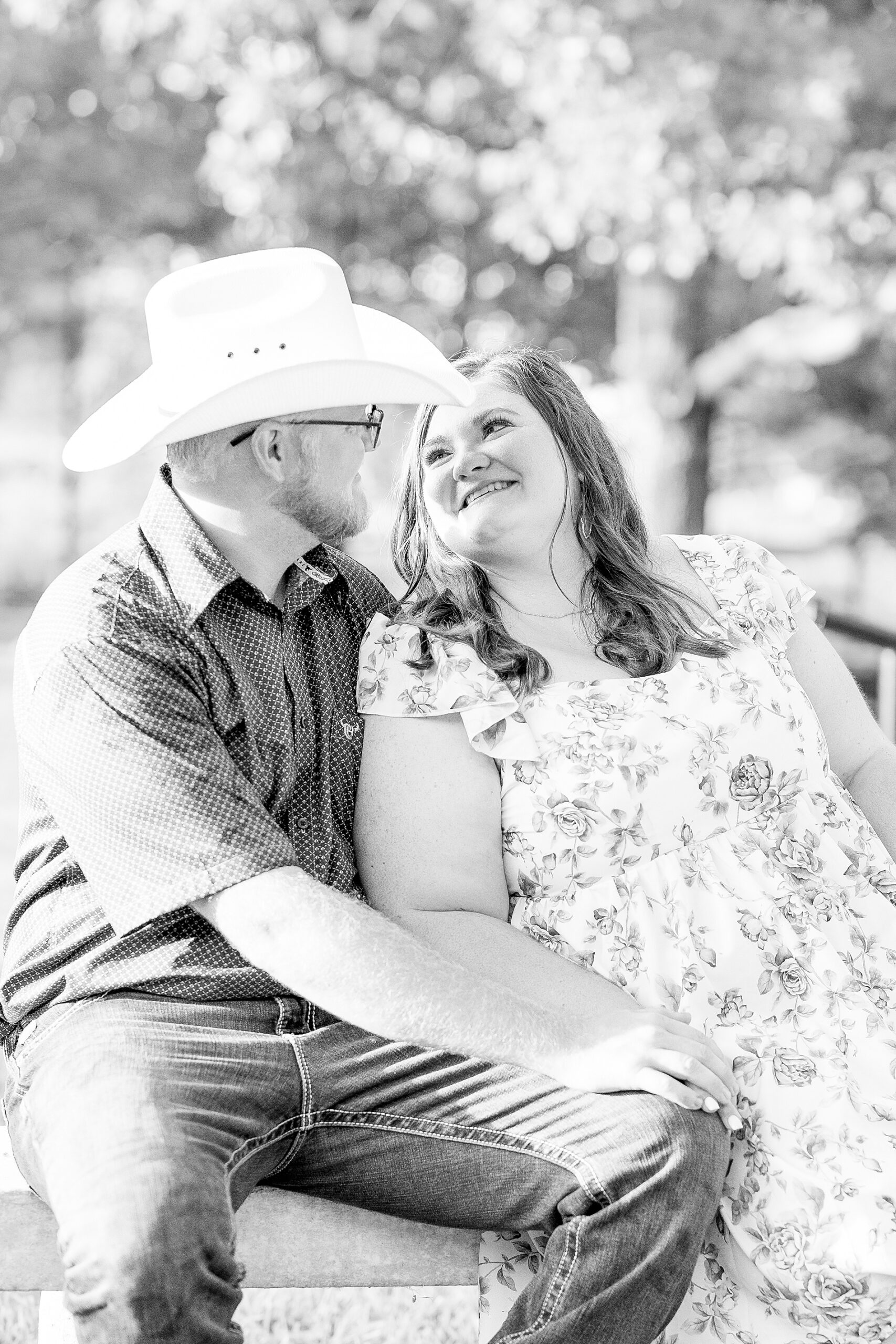 man in cowboy hat sits with fiance