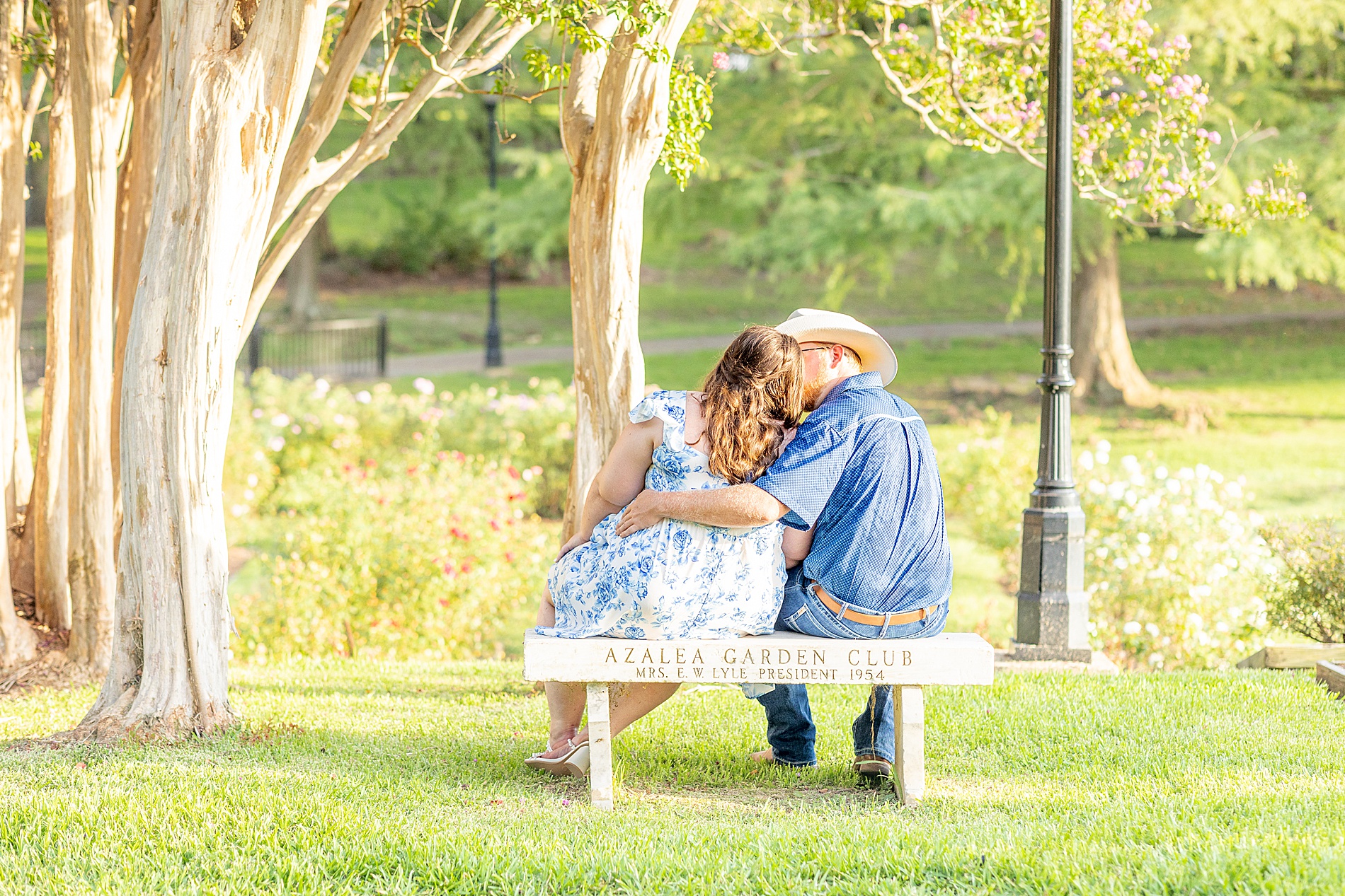 engaged couple sit on bench together