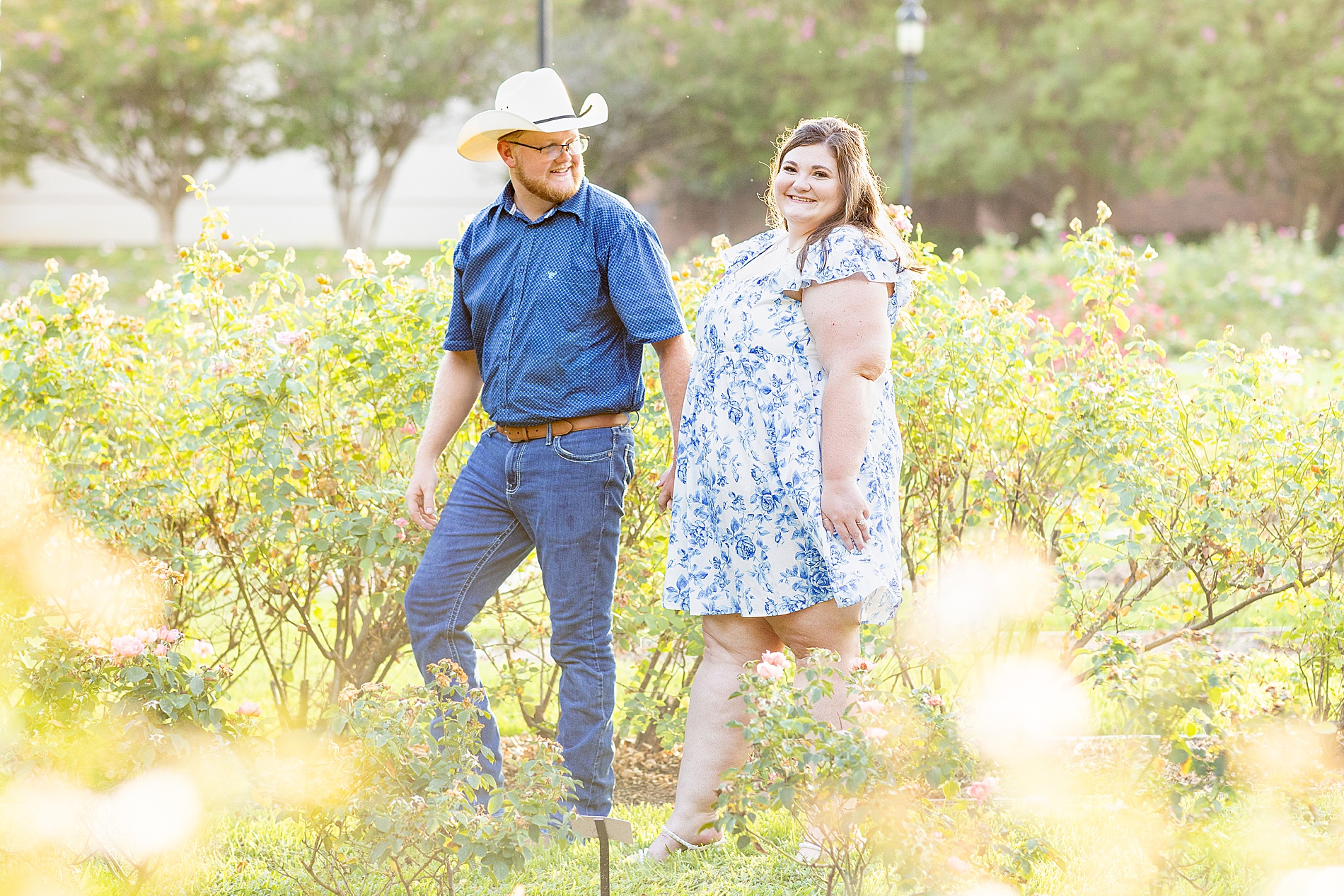 man leads fiance through garden