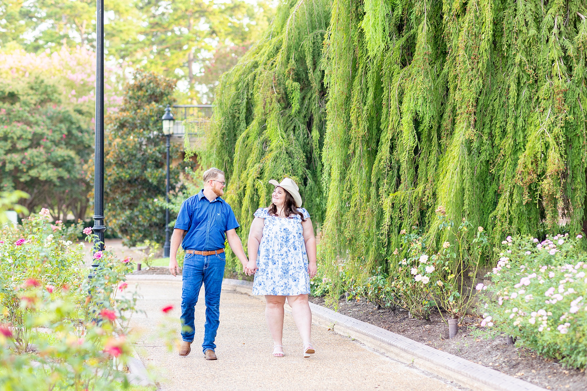 engaged couple walk together holding hands