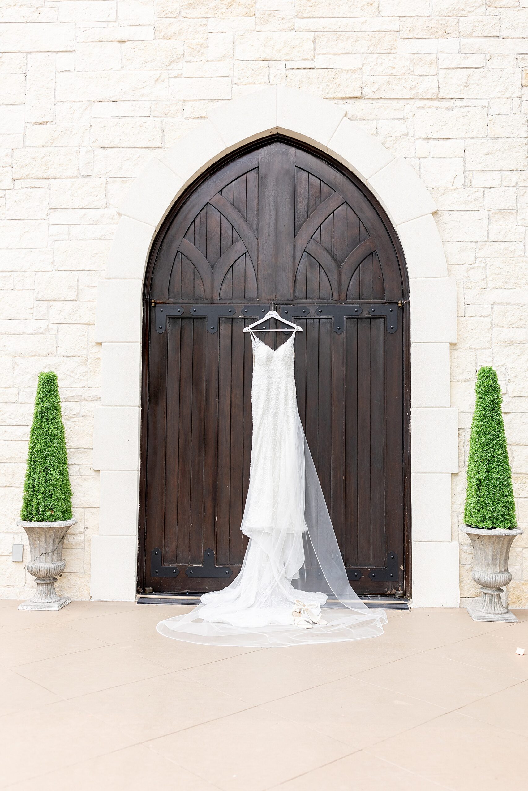 wedding dress hanging from church door