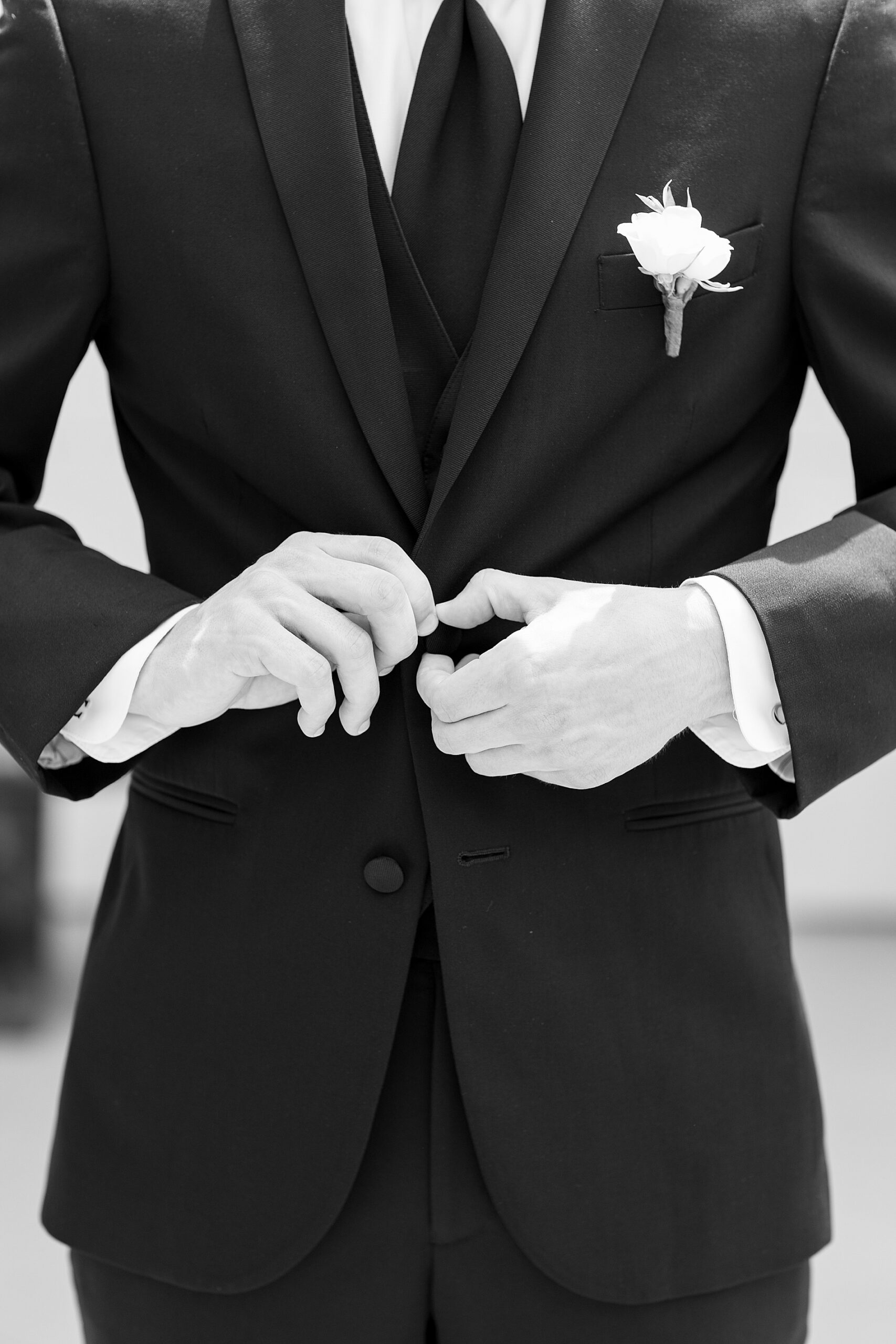 groom puts on jacket