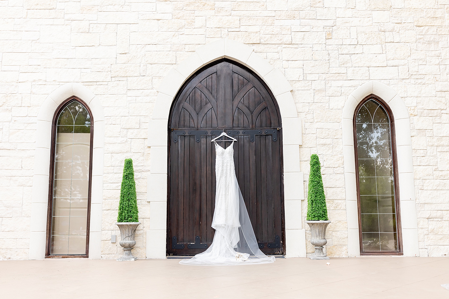 elegant wedding dress hanging from chapel door