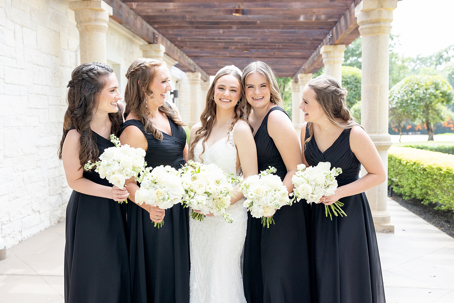 bridesmaids in black bridesmaids dresses with bride