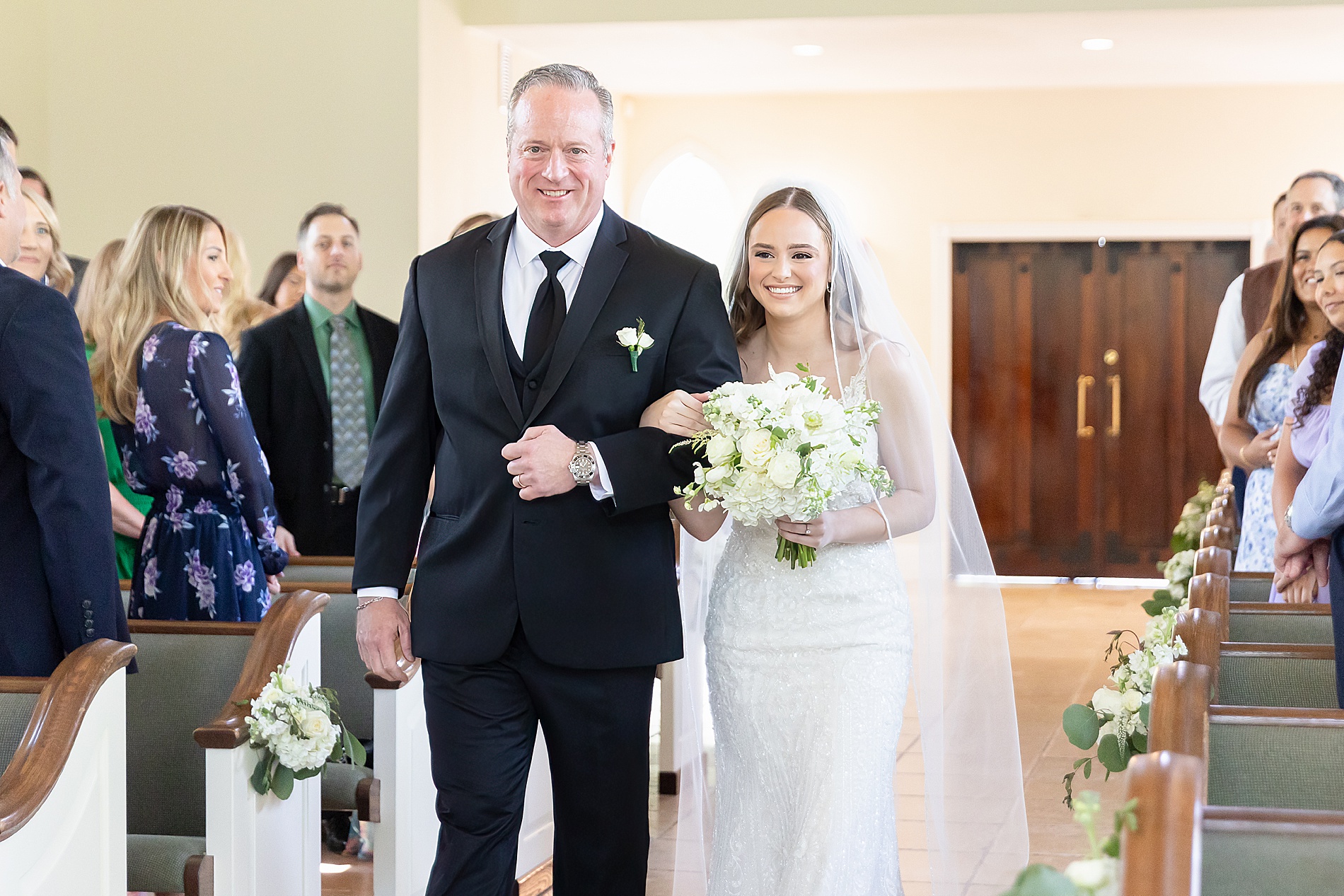 bride walks down the aisle with father 