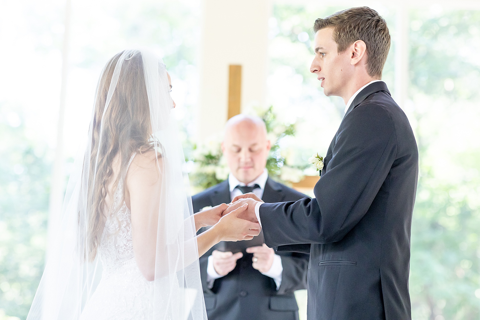 couple exchange wedding rings during ceremony