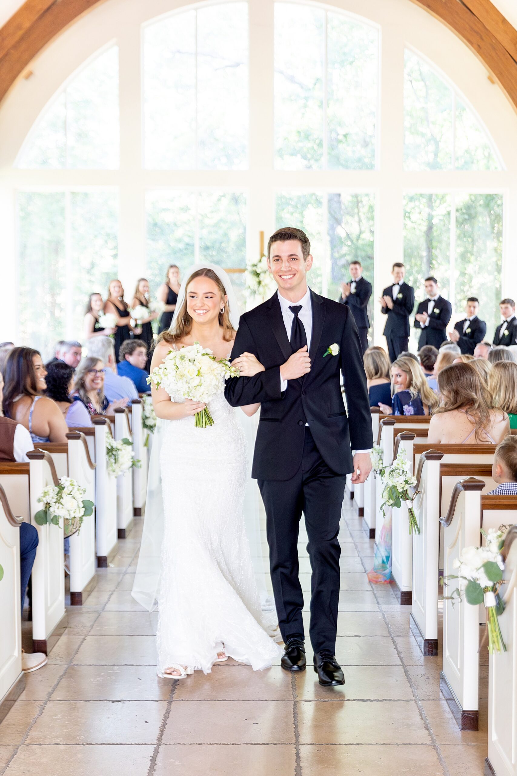 newlyweds exit wedding ceremony at Ashton Gardens chapel