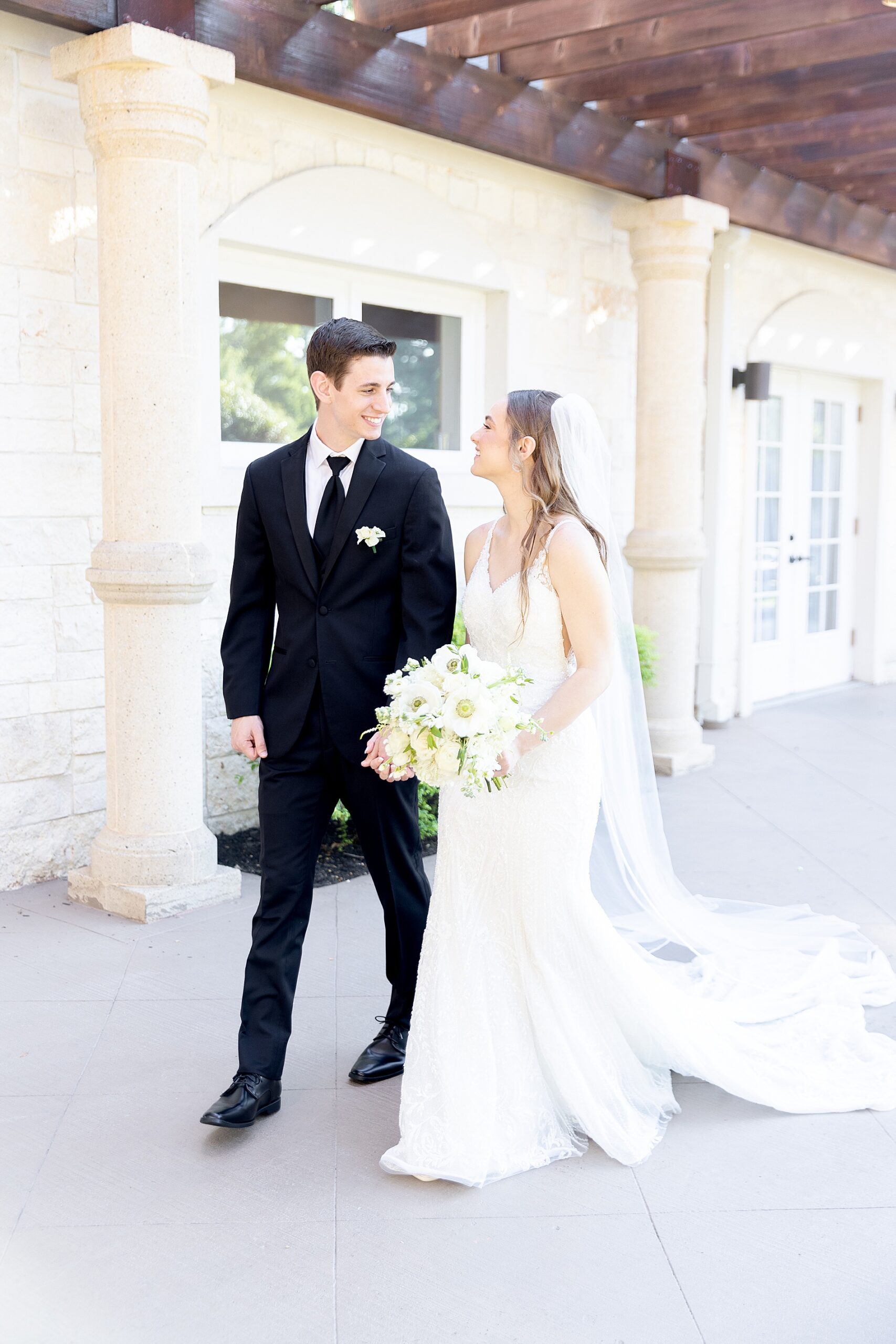 newlyweds walk together holding hands