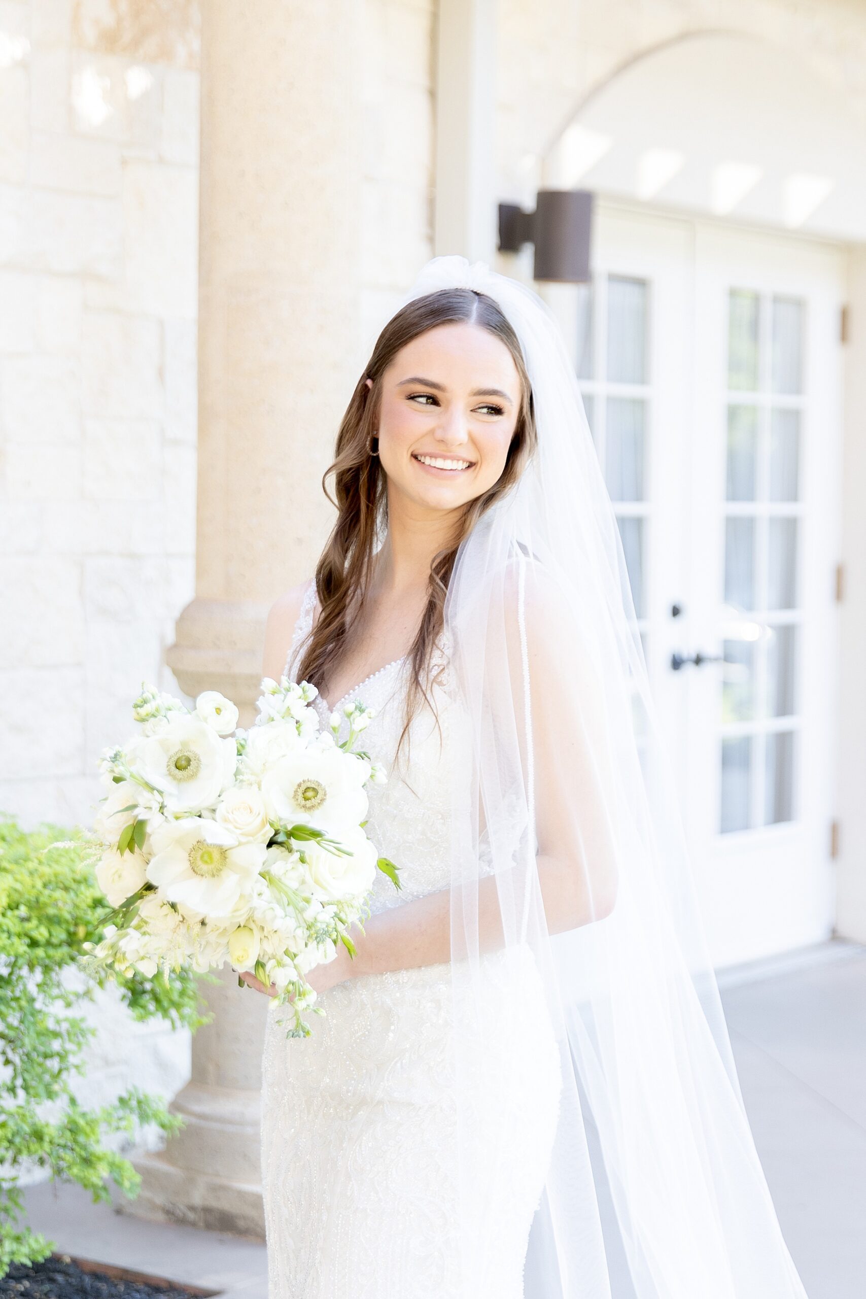 bride holds white bridal bouquet