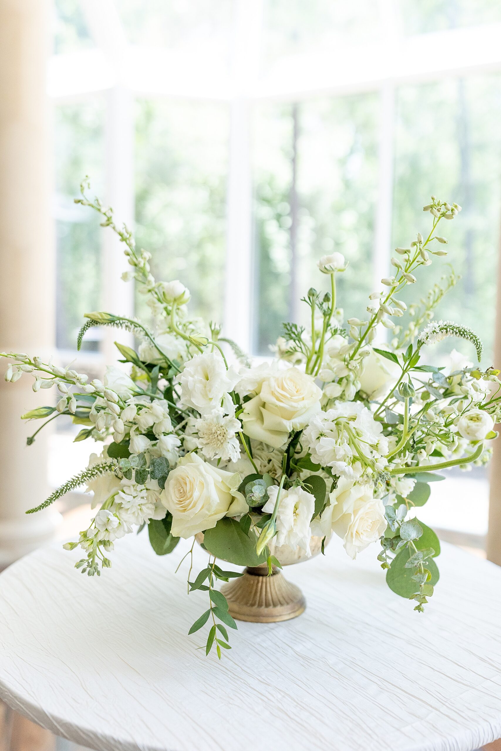 classic and clean white flower arrangement with greenery