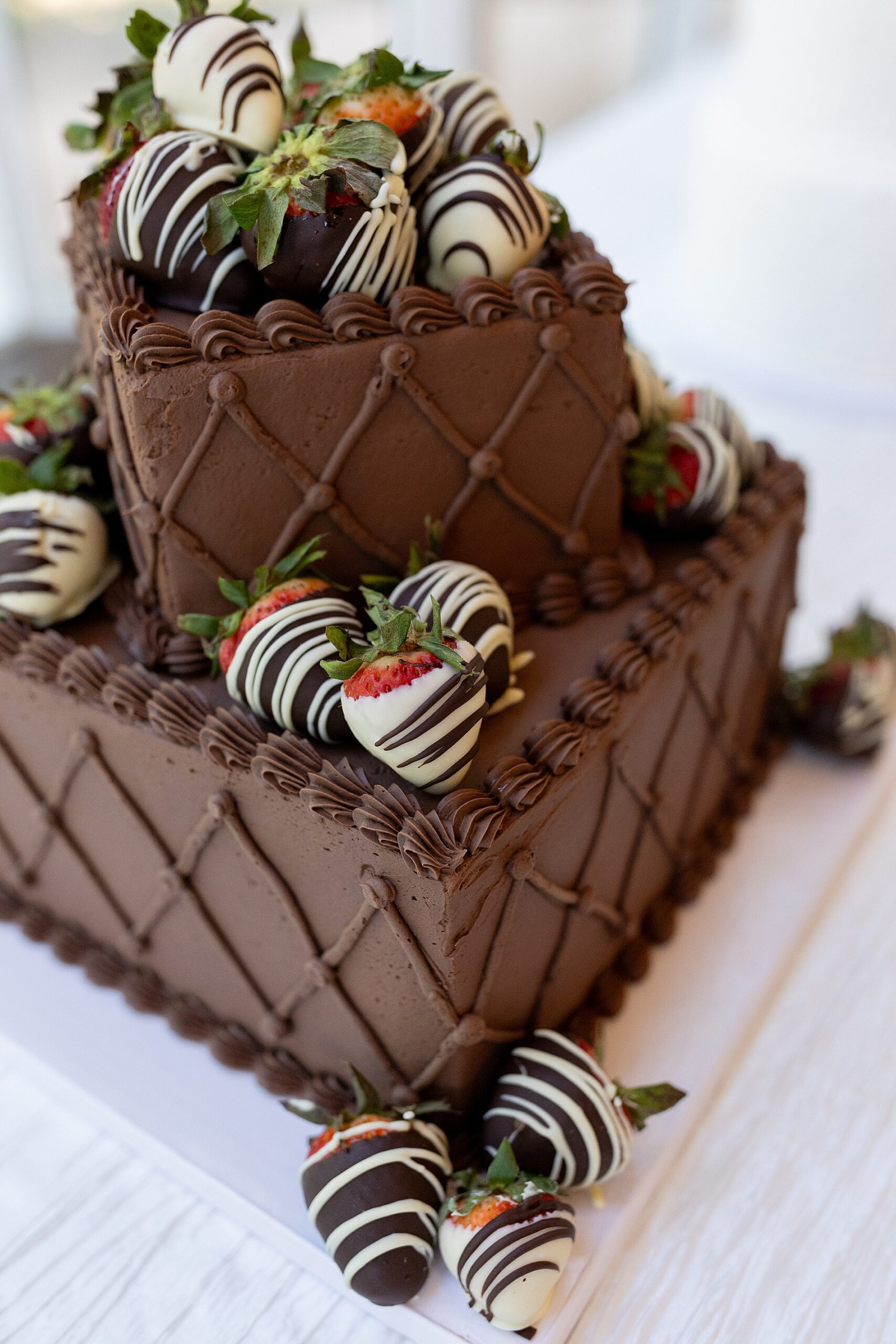 chocolate cake decorated with chocolate covered strawberries