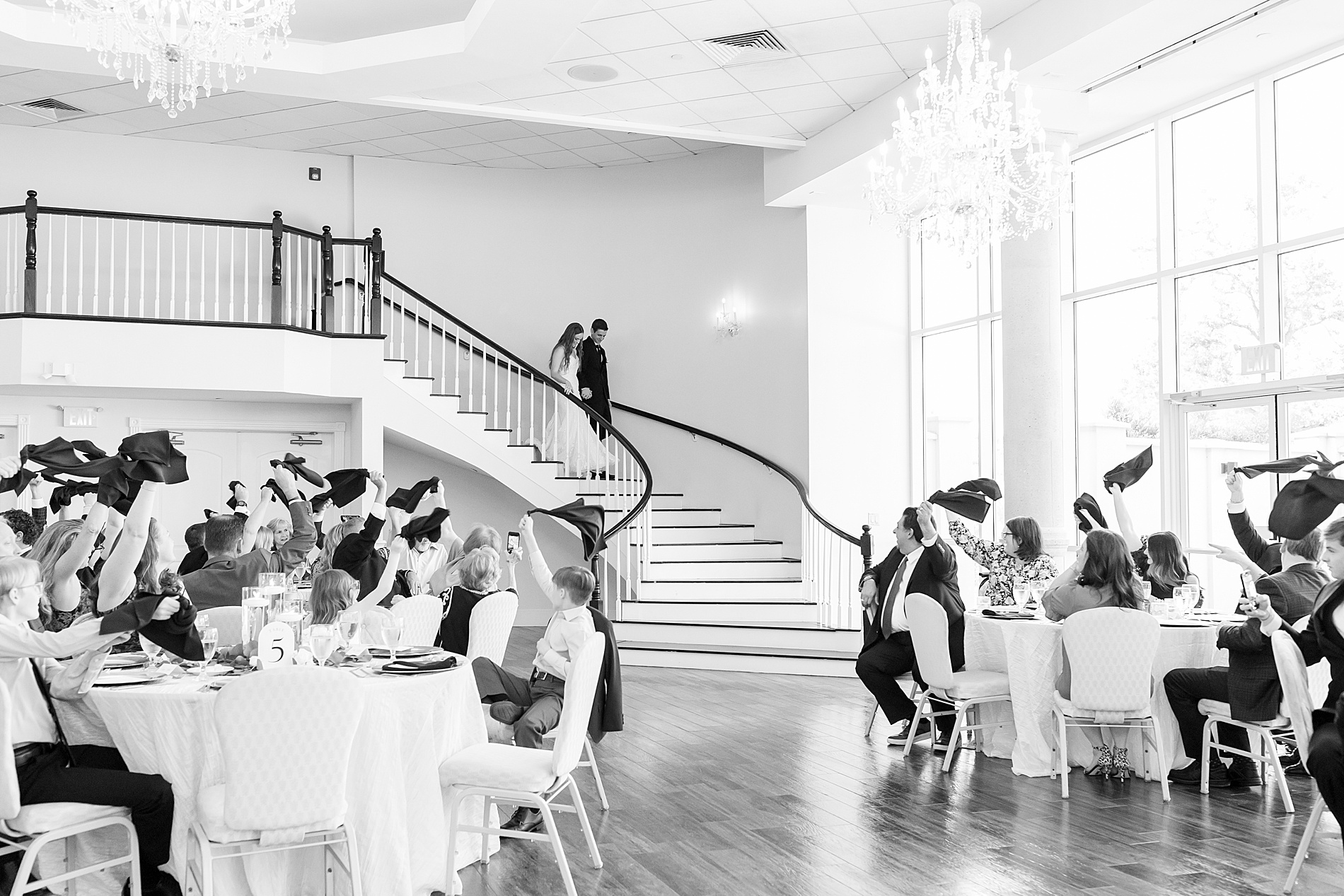 newlyweds walk down spiral staircase