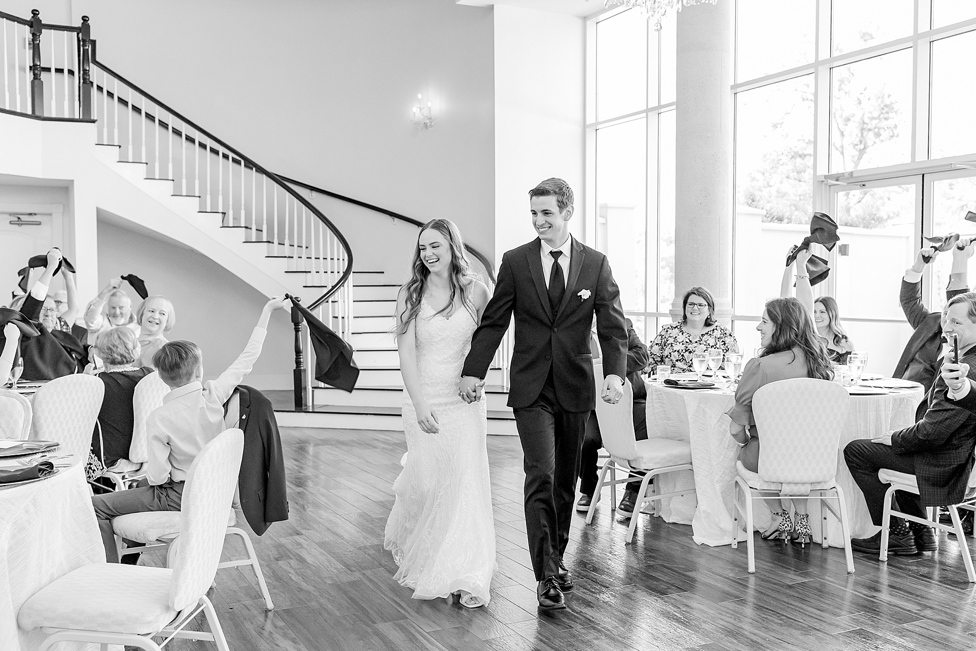 newlyweds enter wedding reception