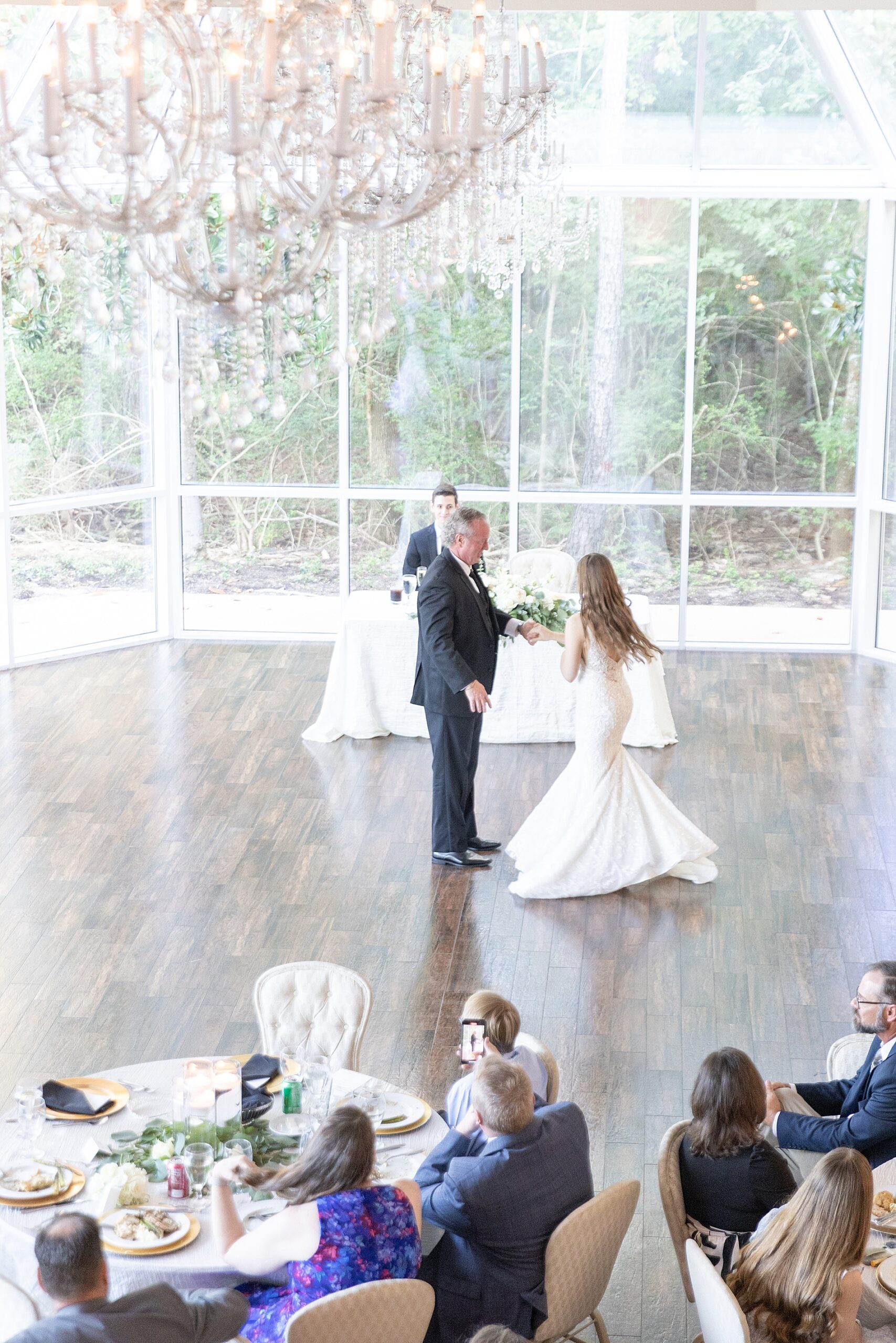 dad spins his daughter around on the dance floor