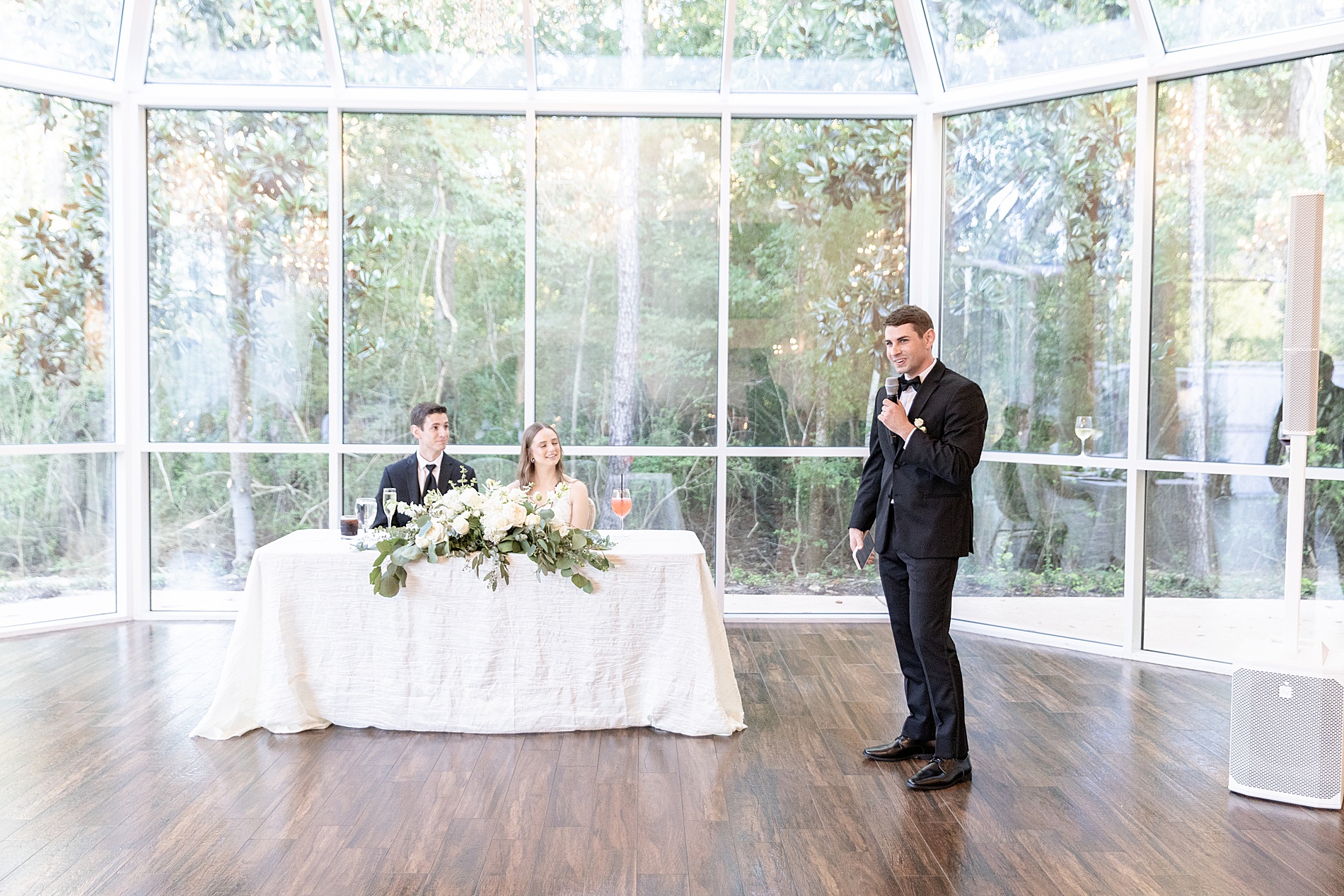 bride and groom listen to wedding speeches