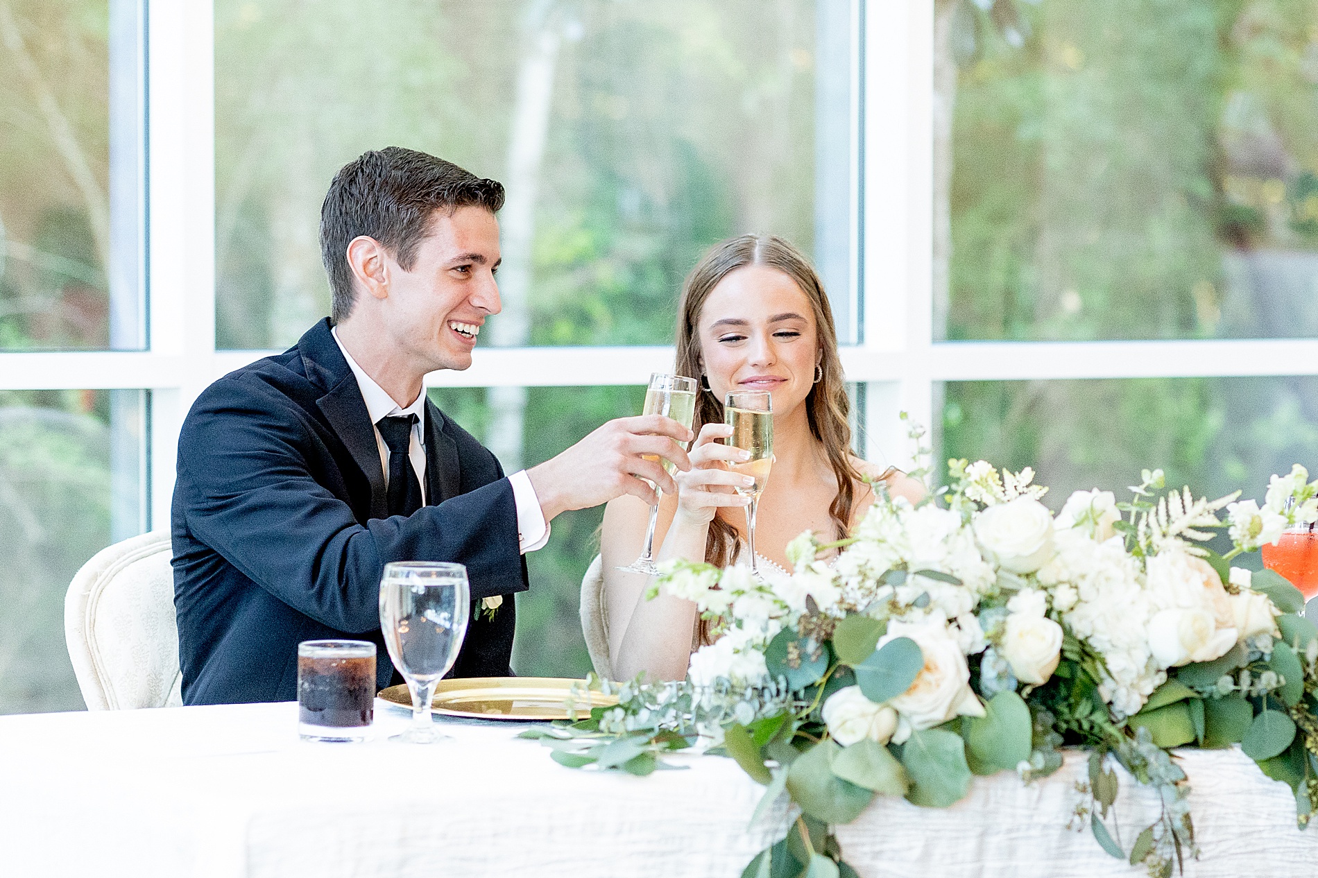 bride and groom toast at wedding reception