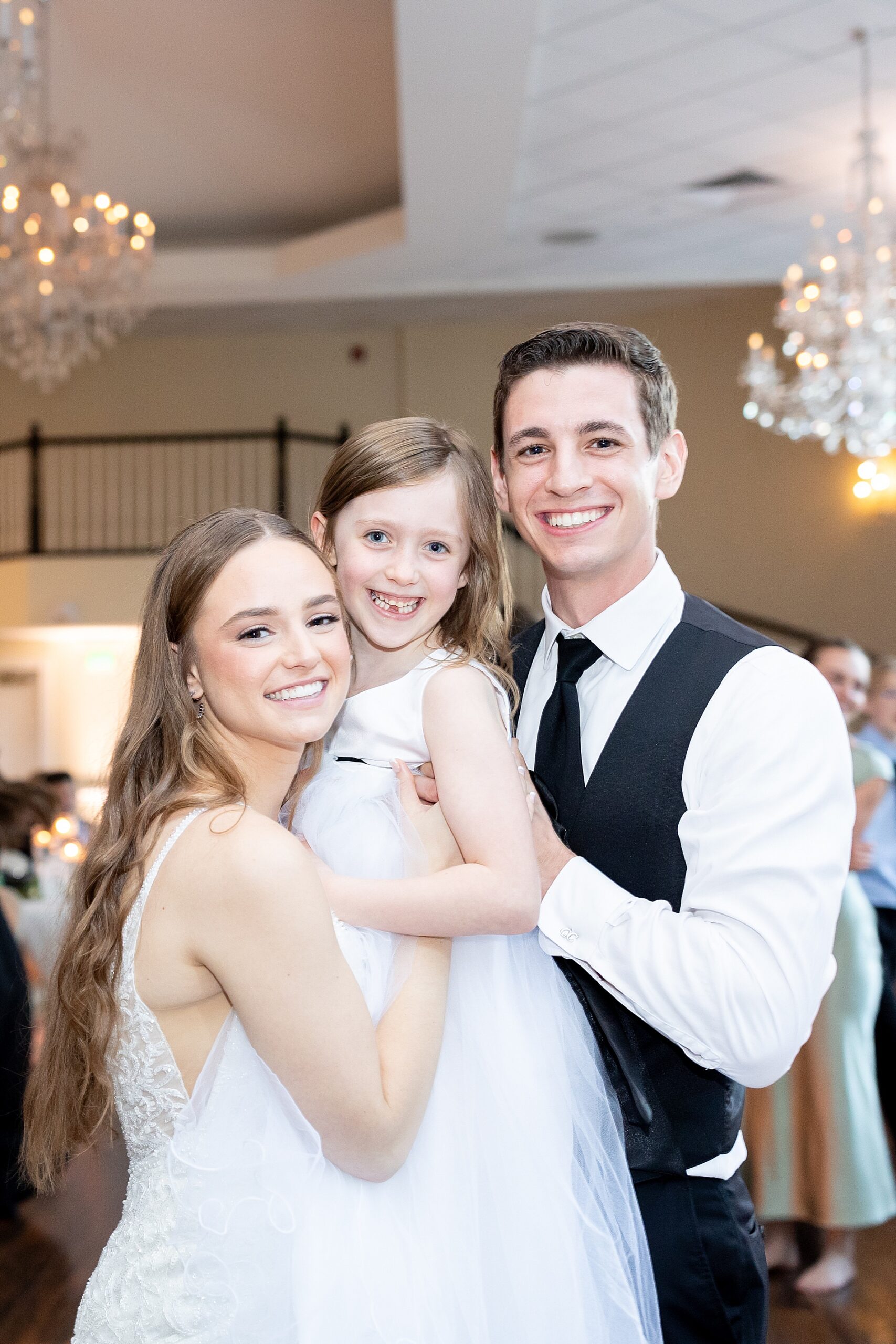 bride and groom with flower girl during Classic Black and White Wedding at Ashton Gardens