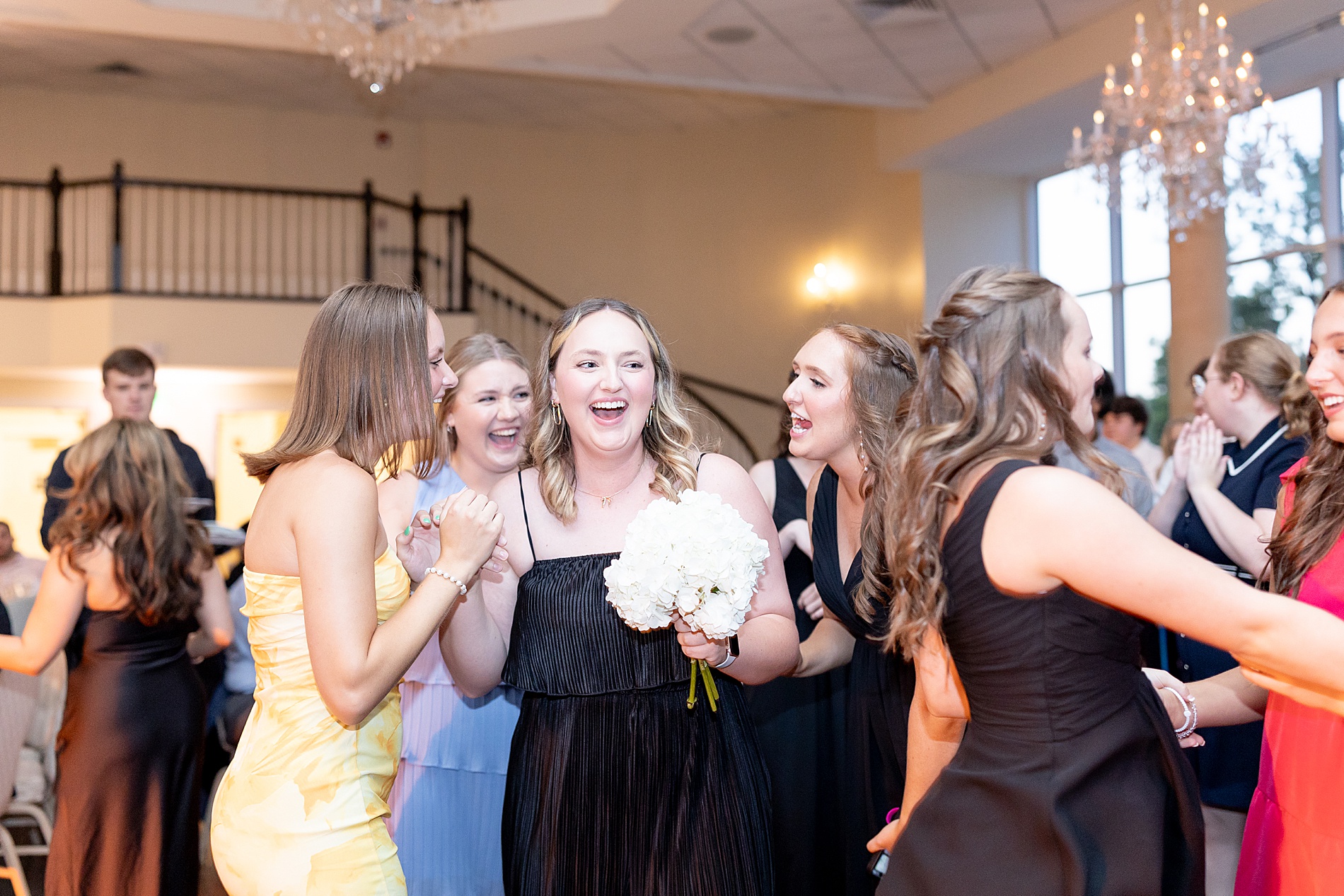 bridesmaid catches bridal bouquet